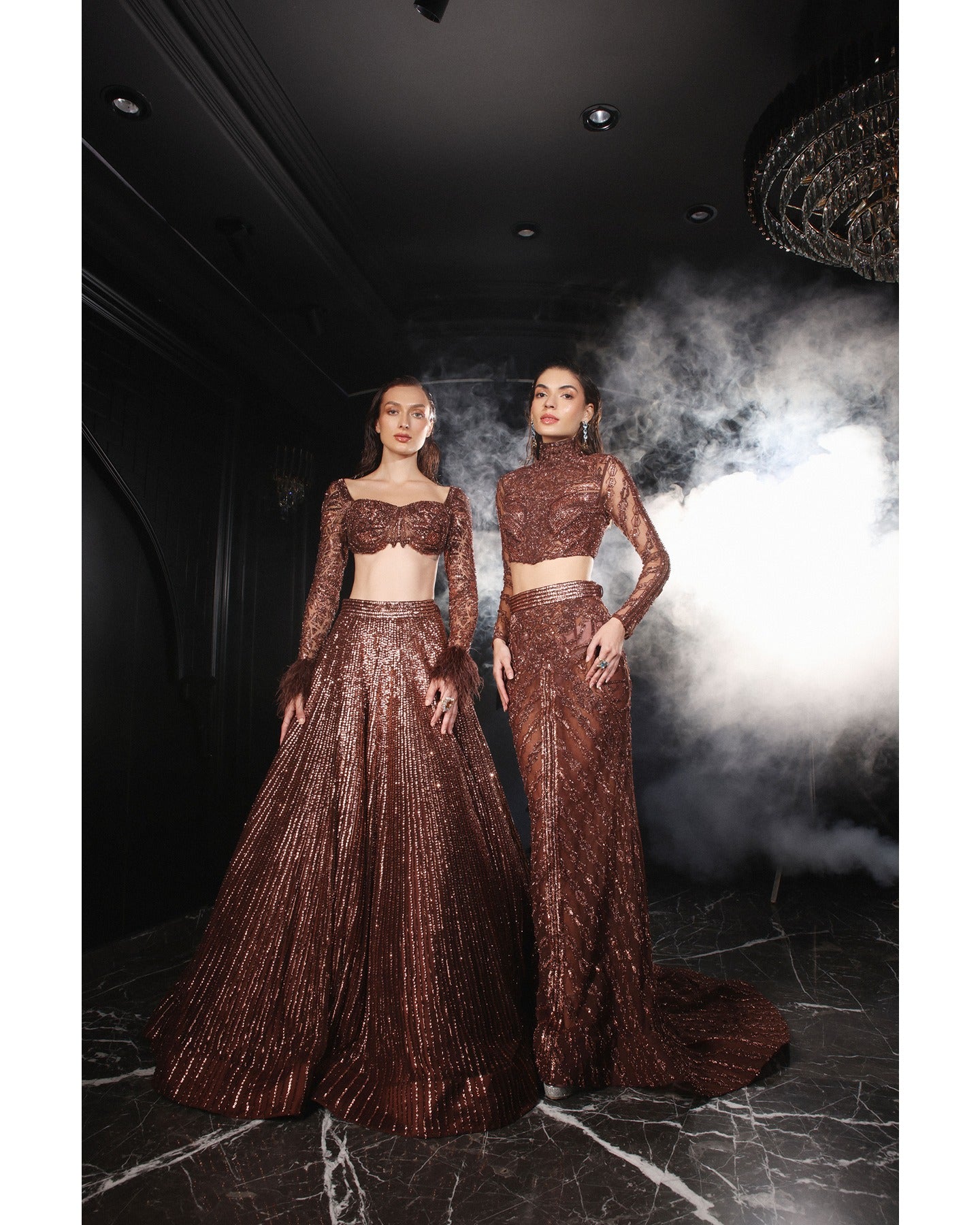 Embrace the allure of the Orave lehenga with its choli cut blouse adorned in Swarovski crystals, feathers, and sequins, complemented by a captivating feather cape.