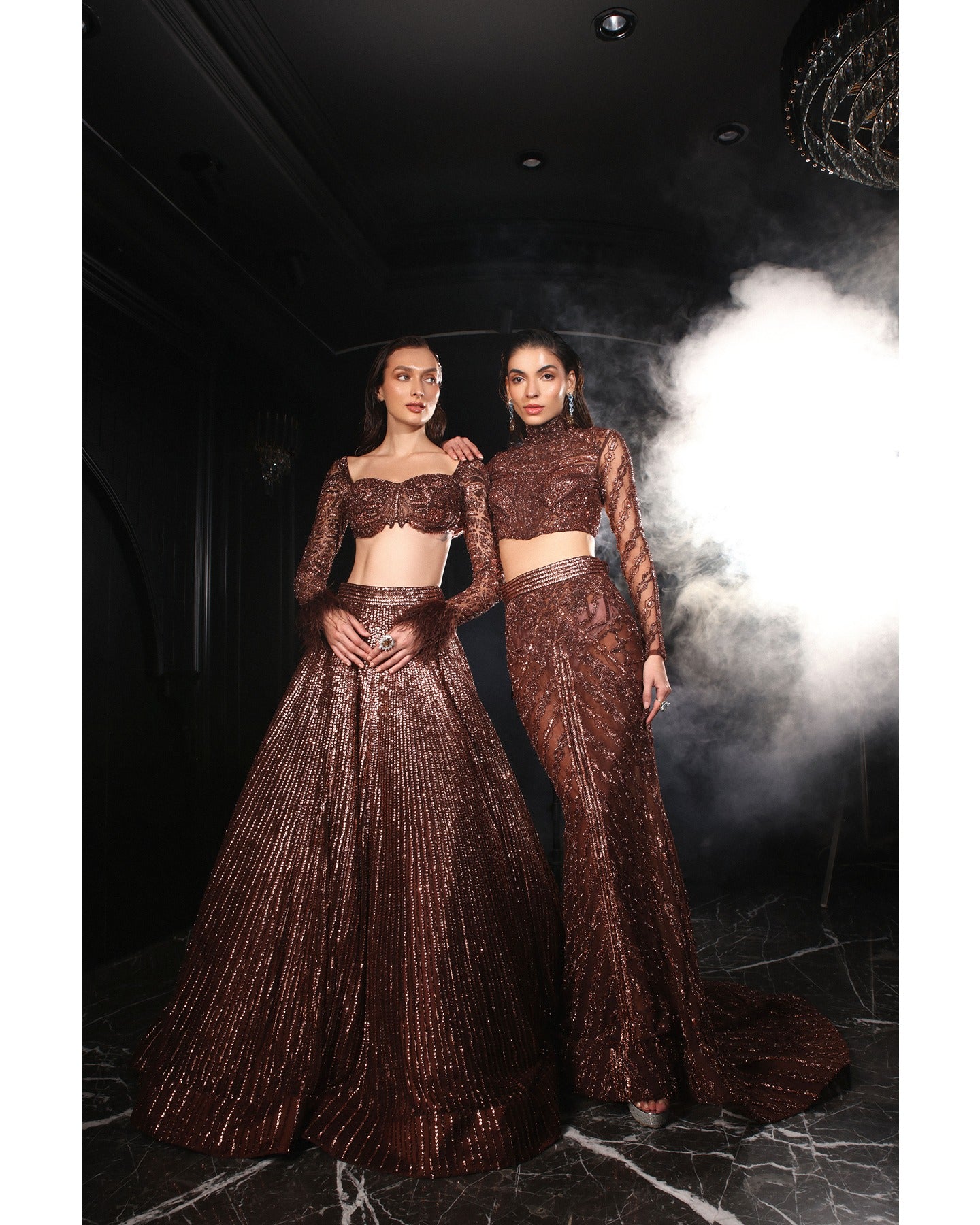 Embrace the allure of the Orave lehenga with its choli cut blouse adorned in Swarovski crystals, feathers, and sequins, complemented by a captivating feather cape.