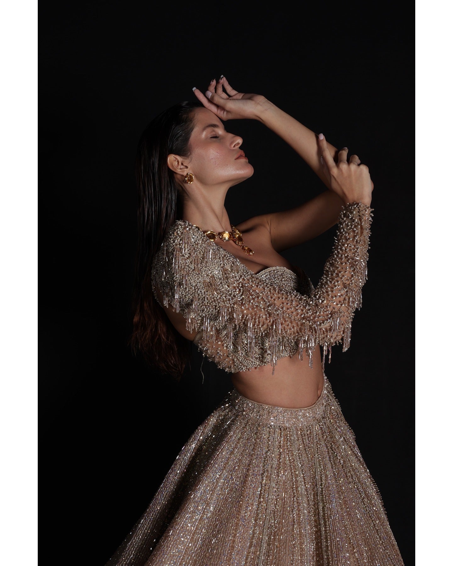 Elevate your elegance in our Champagne Lehenga, a sparkling symphony of stones, crystals, sequins, and Japanese cut-dana.