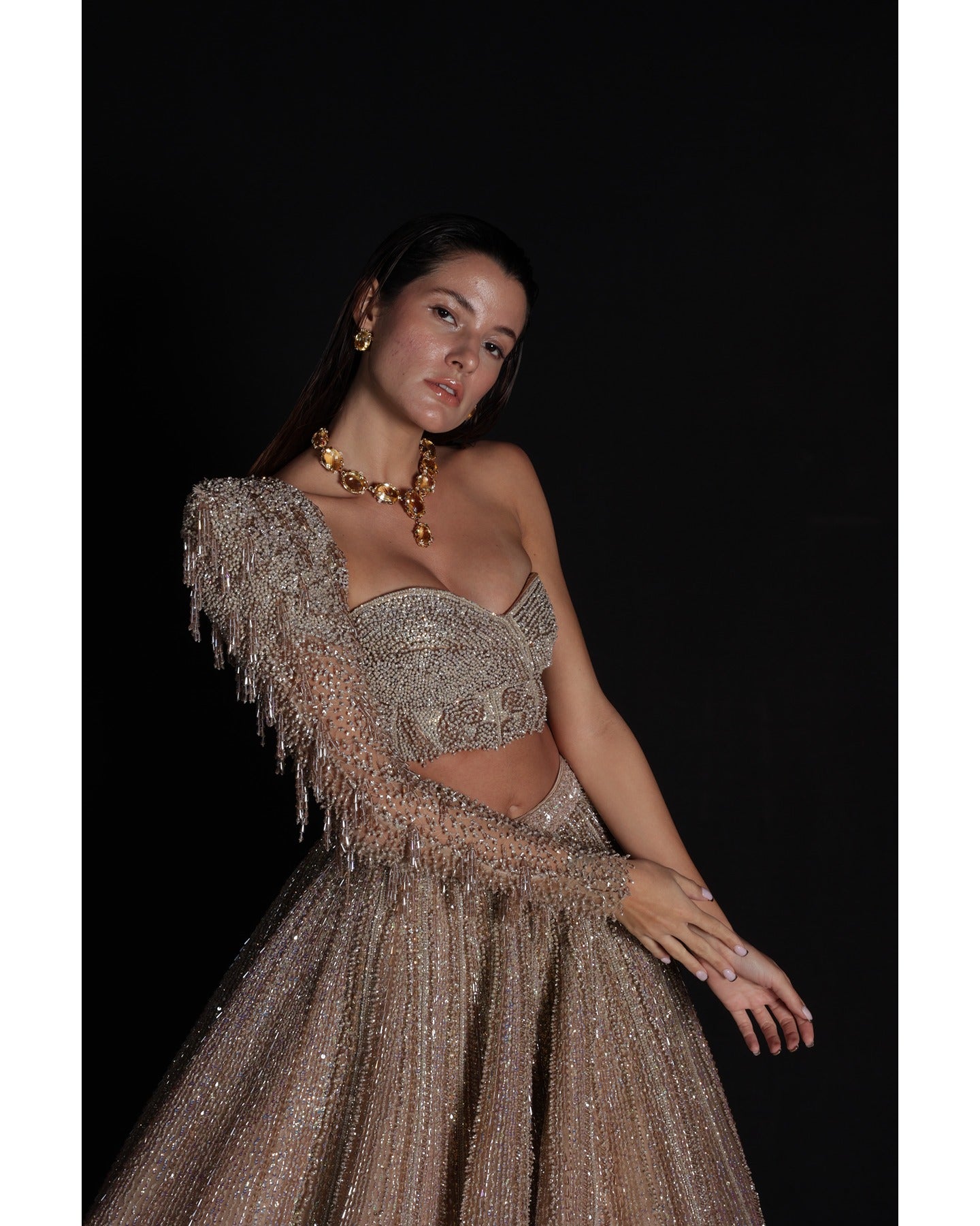 Elevate your elegance in our Champagne Lehenga, a sparkling symphony of stones, crystals, sequins, and Japanese cut-dana.