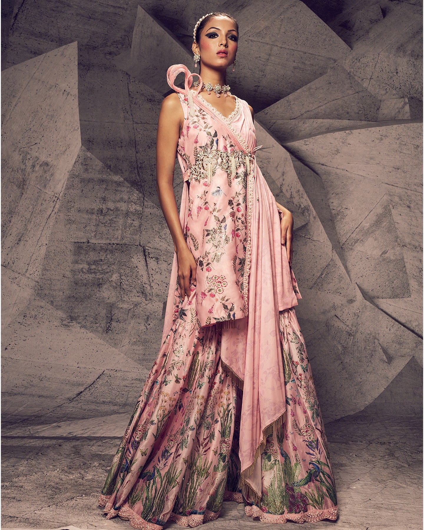Bathed in the enchanting hues of pink, this sharara ensemble is adorned with delicate pearl embroidery, creating a look that is both graceful and timeless.