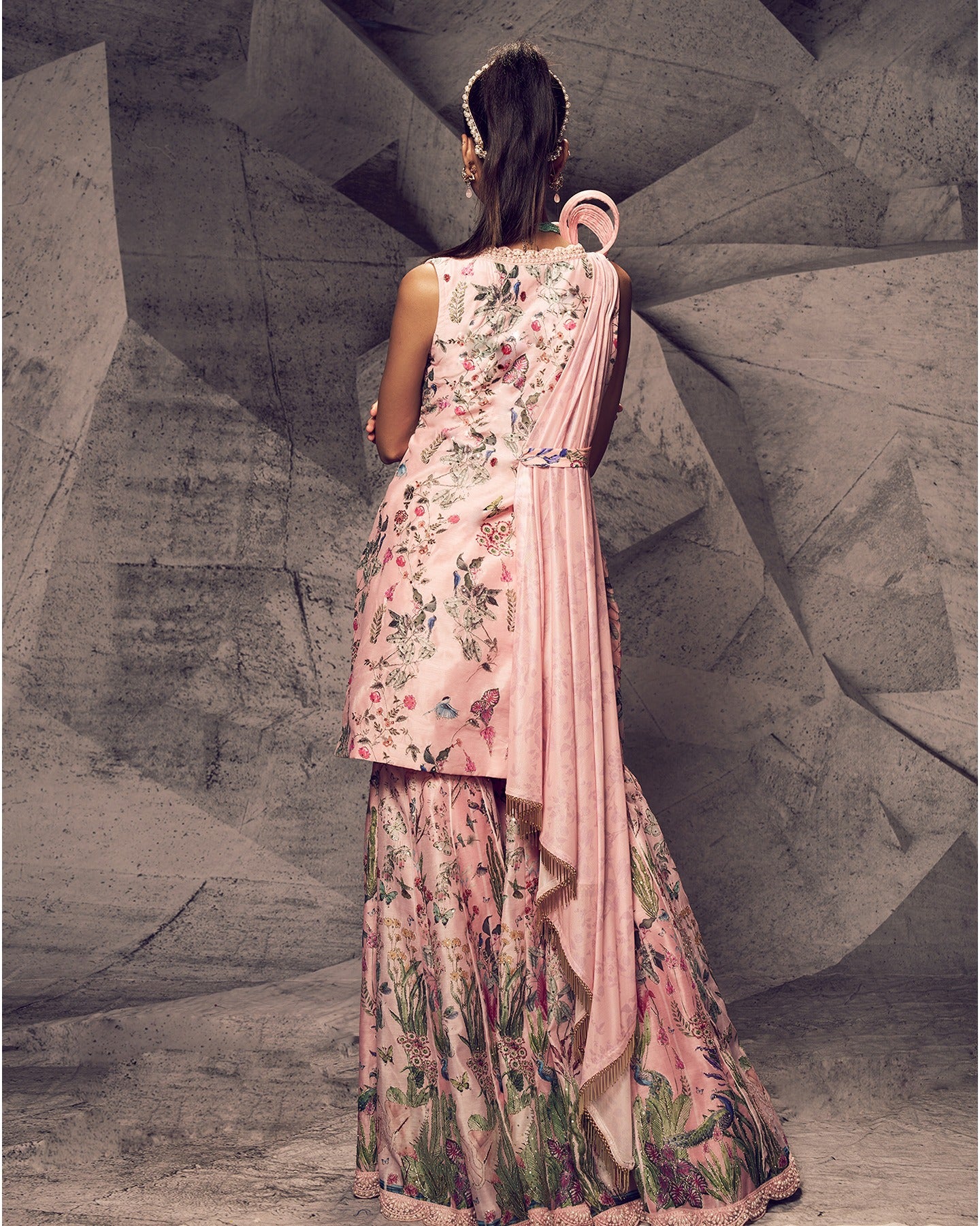Bathed in the enchanting hues of pink, this sharara ensemble is adorned with delicate pearl embroidery, creating a look that is both graceful and timeless.