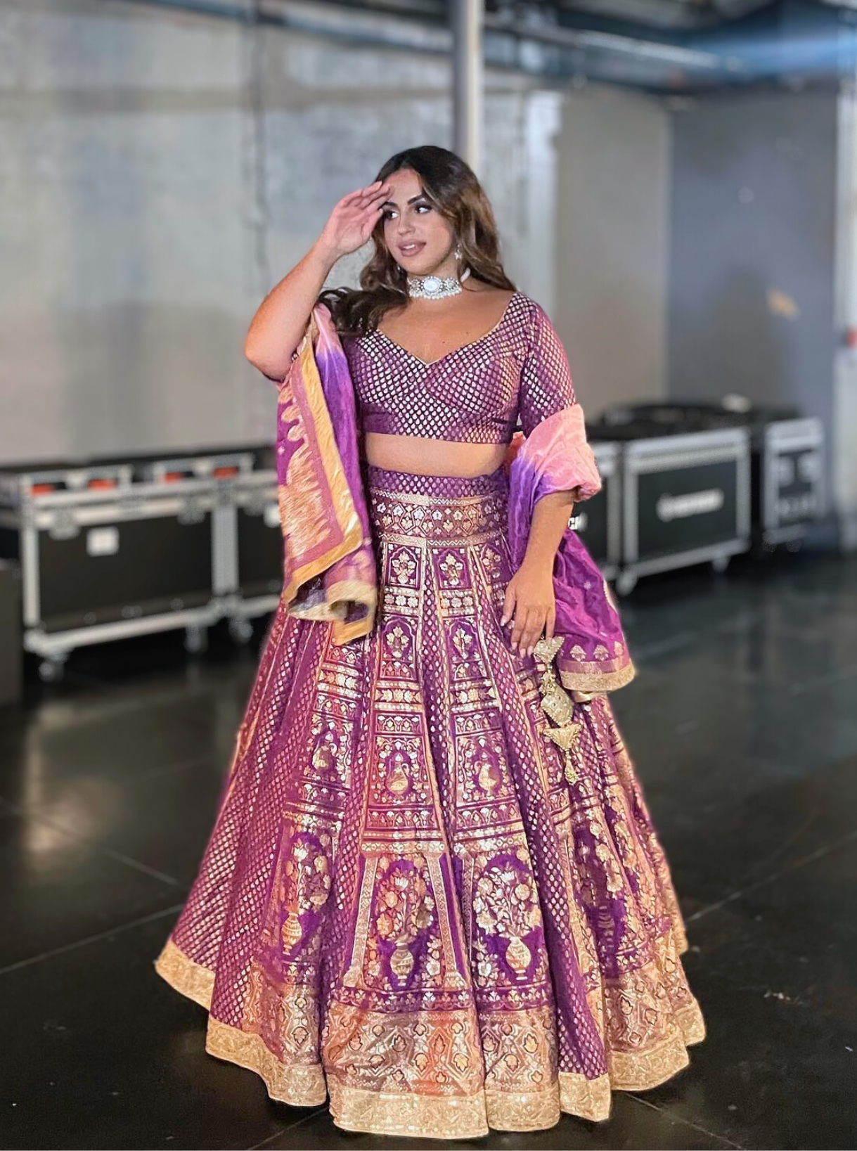 Bride's stunning ensemble – a purple and gold bridal lehenga with intricate embroidery.