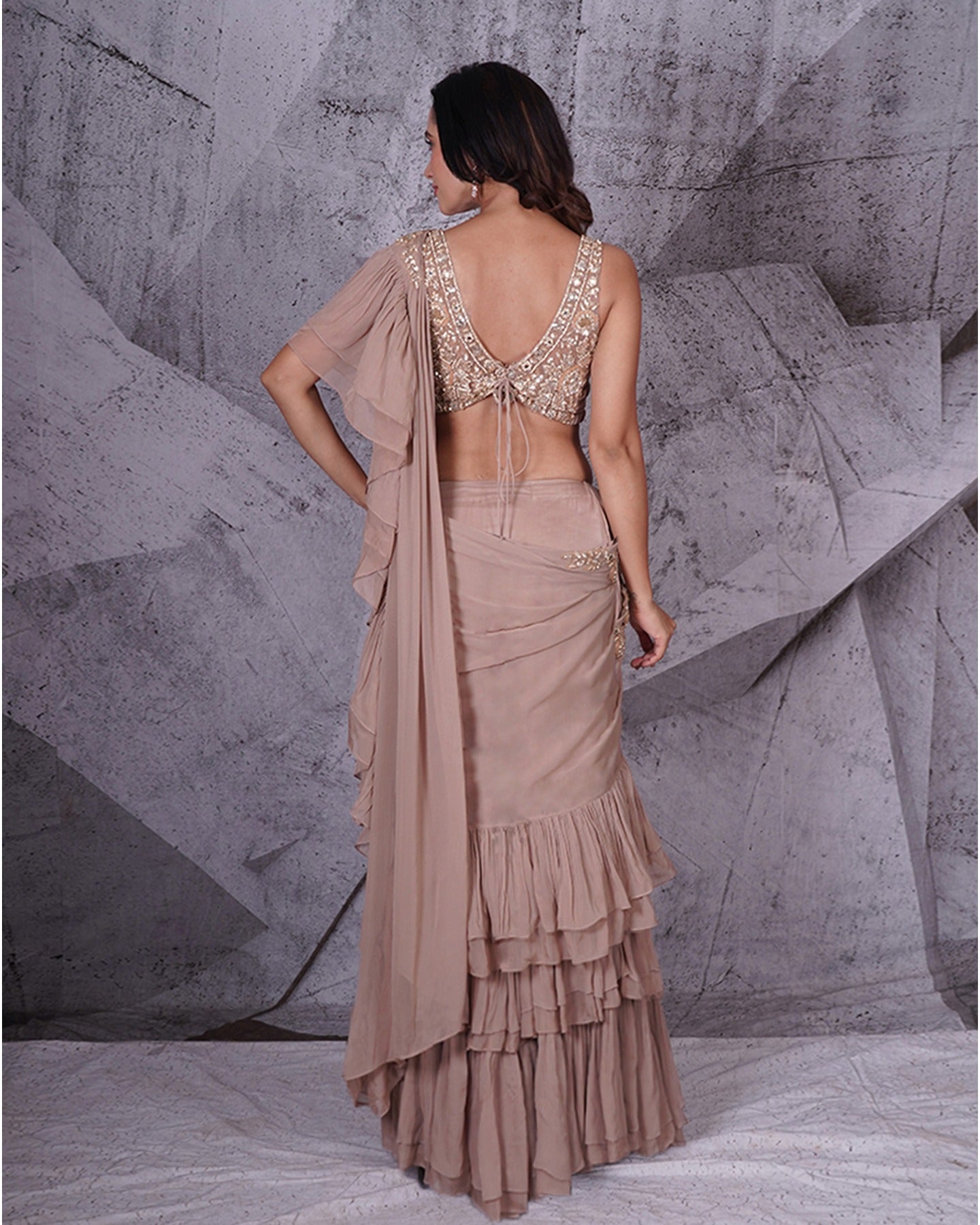 Draped in the subtle elegance of beige, this saree weaves a tale of timeless grace. A canvas of sophistication that speaks volumes in every fold.