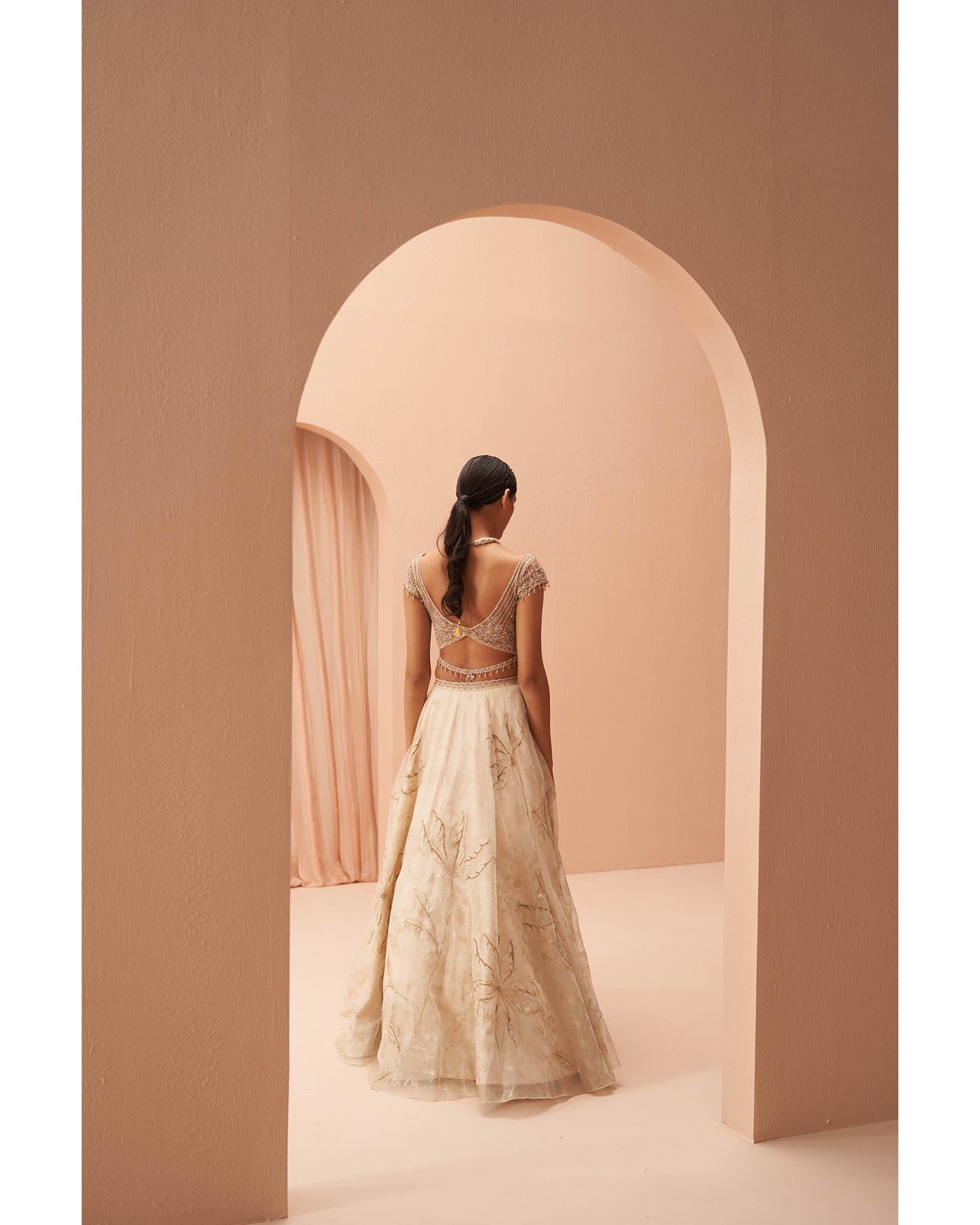 Gilded in Grace: This off-white and gold lehenga is a canvas of hand-embroidered elegance.