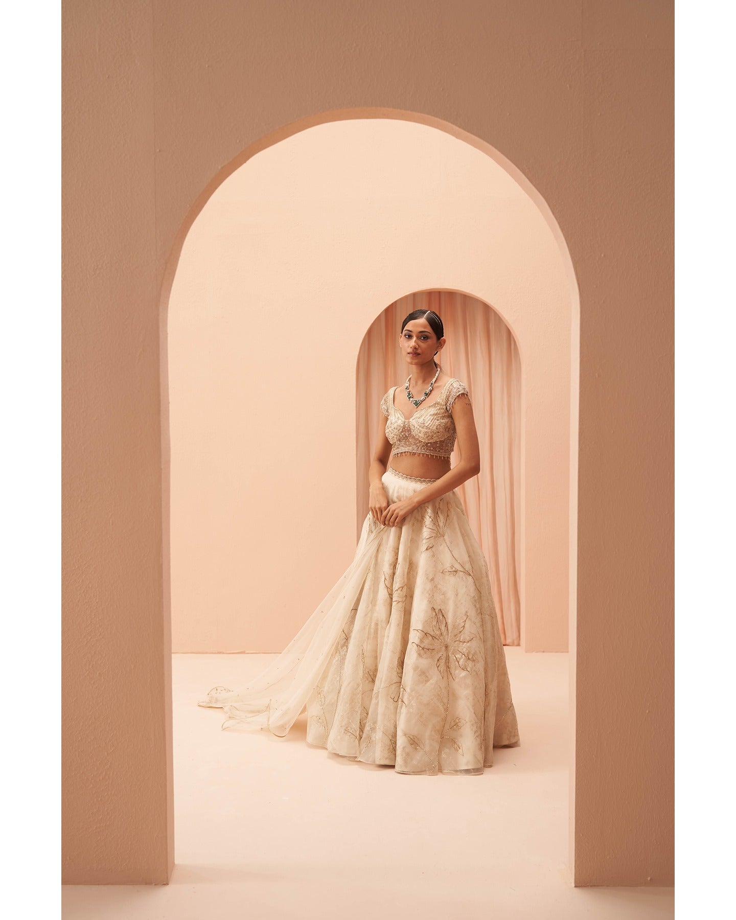 Gilded in Grace: This off-white and gold lehenga is a canvas of hand-embroidered elegance.