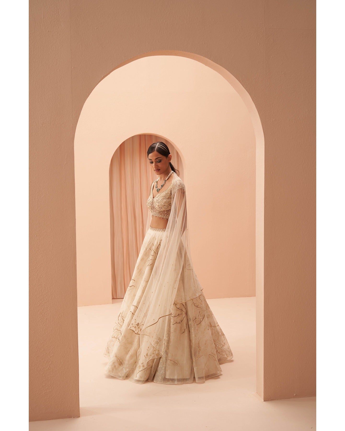 Gilded in Grace: This off-white and gold lehenga is a canvas of hand-embroidered elegance.