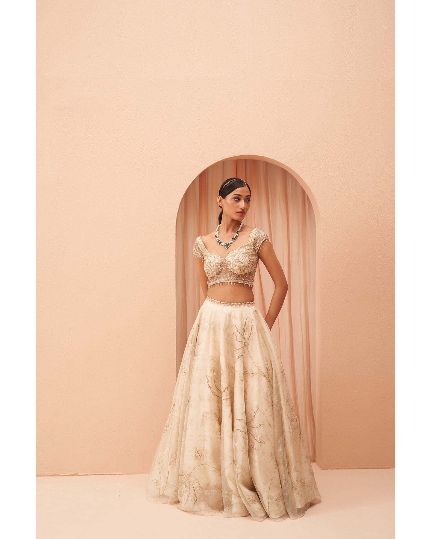 Gilded in Grace: This off-white and gold lehenga is a canvas of hand-embroidered elegance.