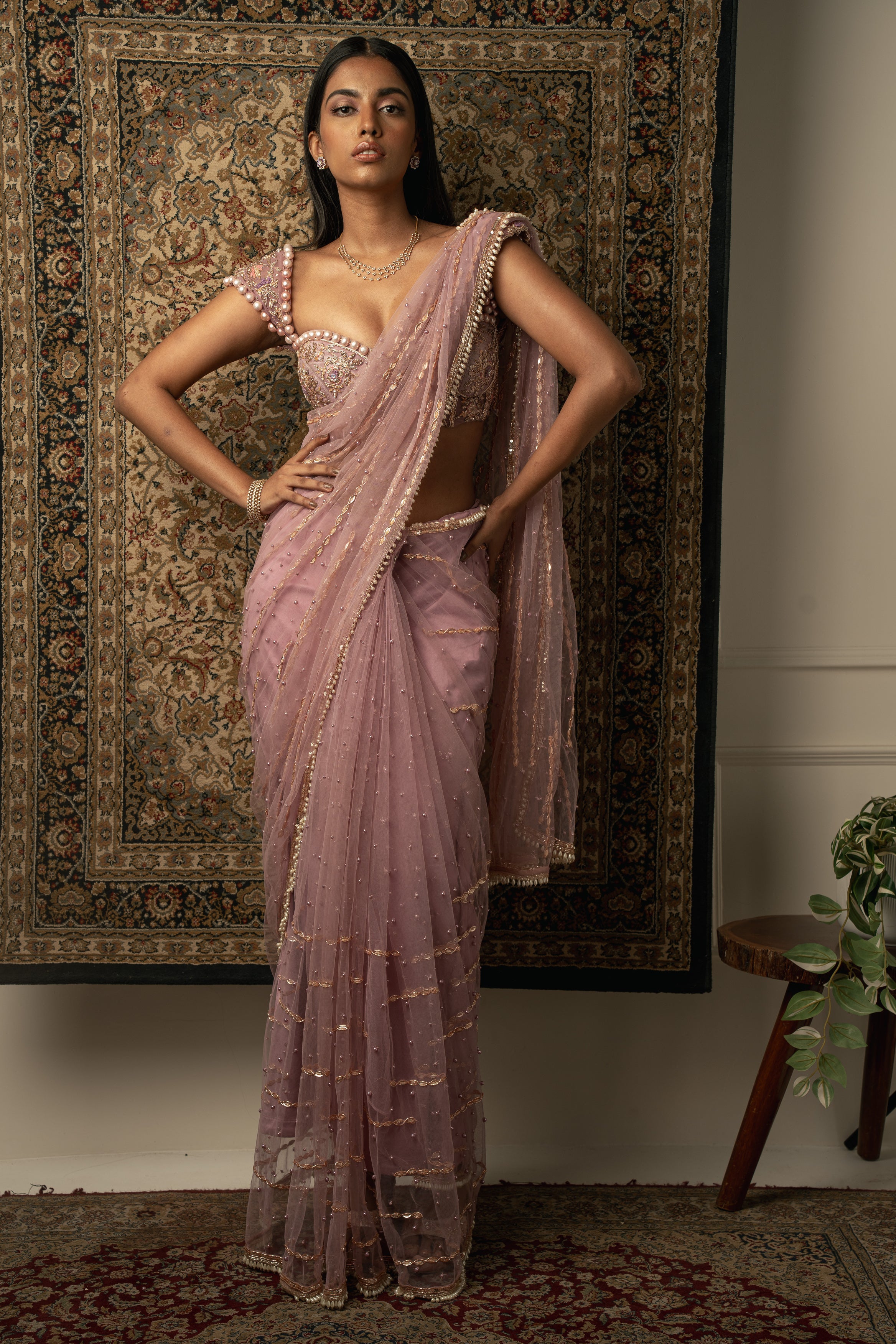 Elevate your grace with this Lilac Net Saree paired with a luxurious Velvet and Net blouse, a vision of sheer beauty.