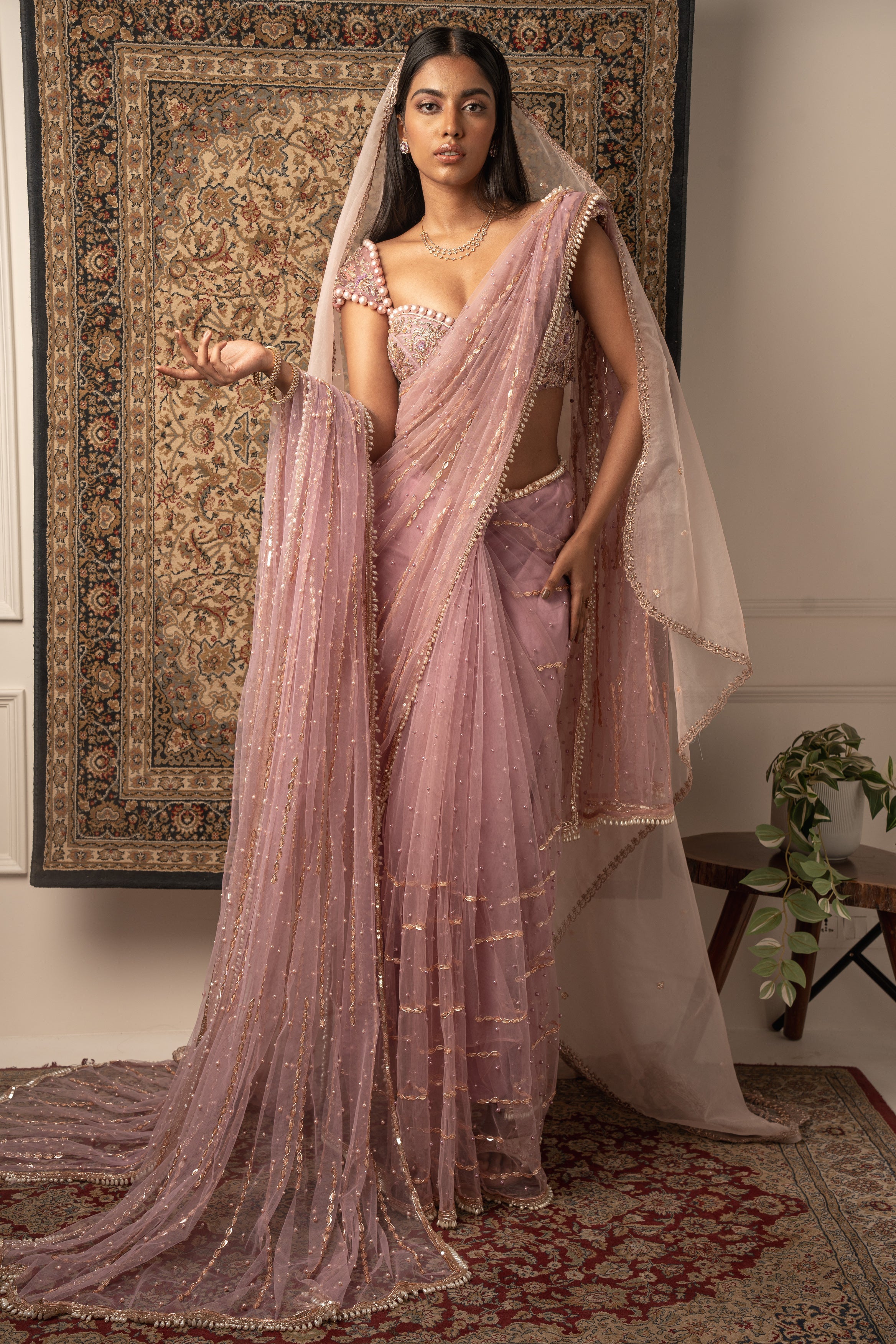 Draped in dreams: Lilac Net Saree with a Velvet and Net blouse, exuding ethereal charm and timeless elegance.