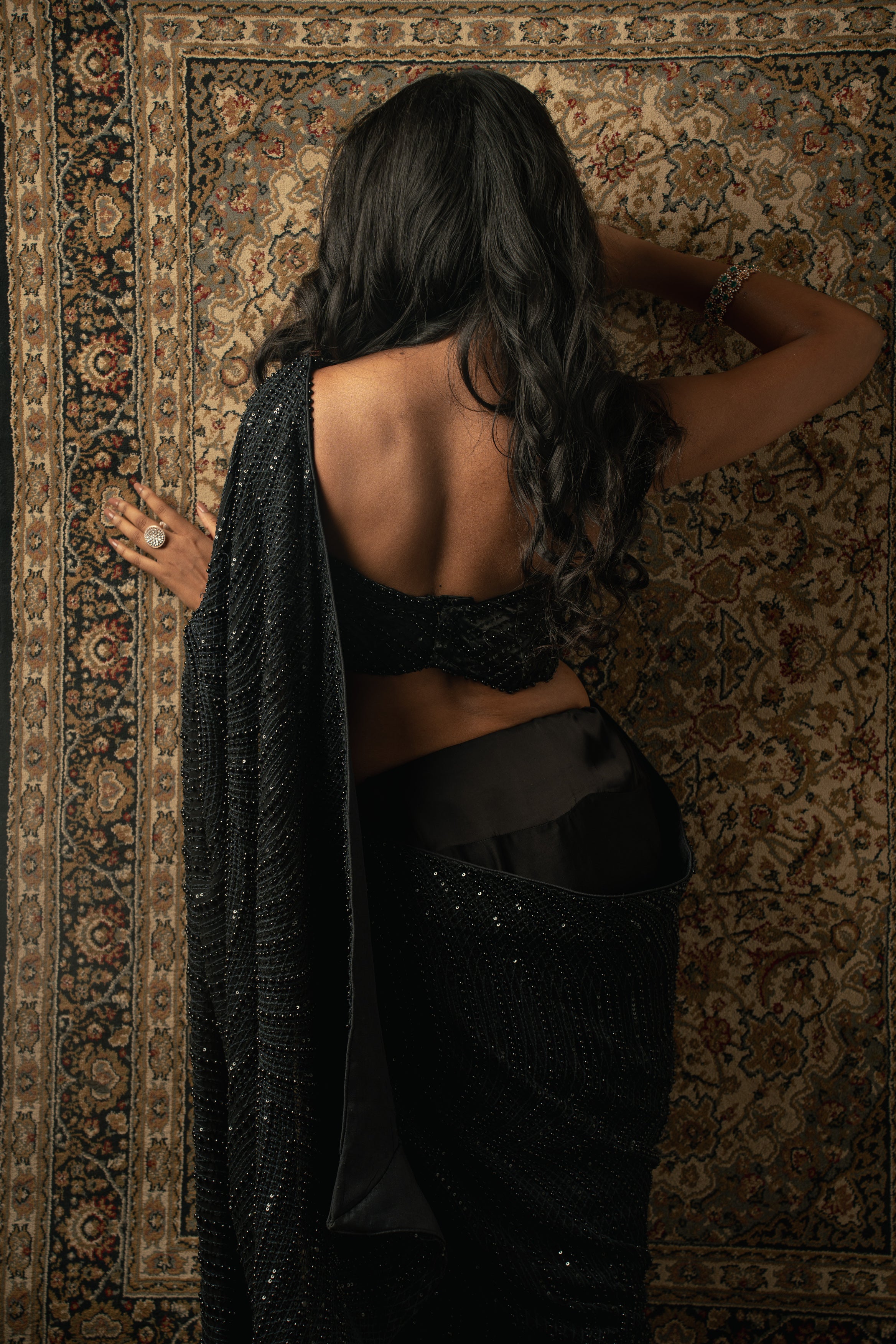 Embrace the allure of black with this meticulously crafted saree ensemble. Perfect for those special occasions.