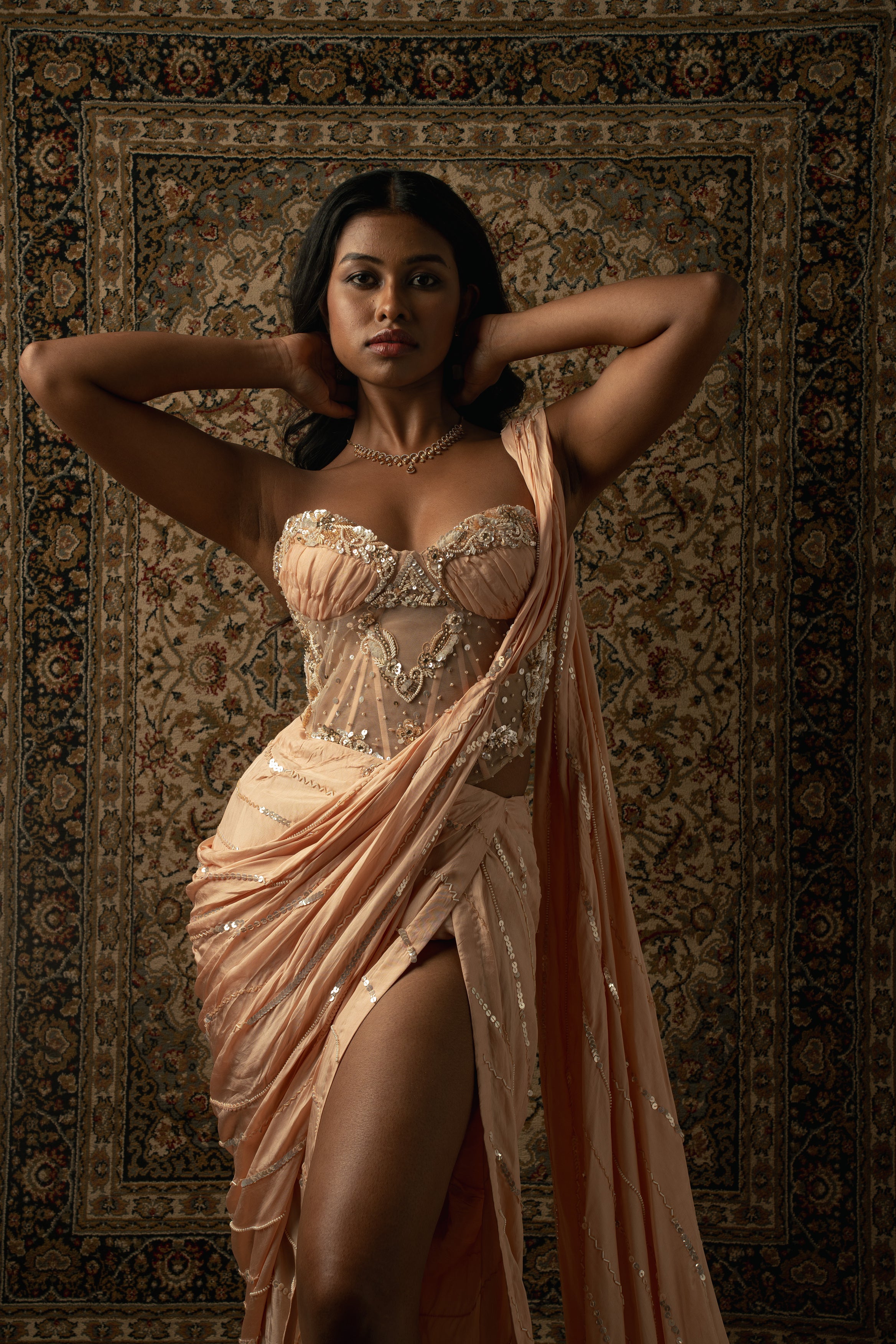Radiate sophistication: This peach satin silk saree and net blouse ensemble exudes timeless charm and grace.