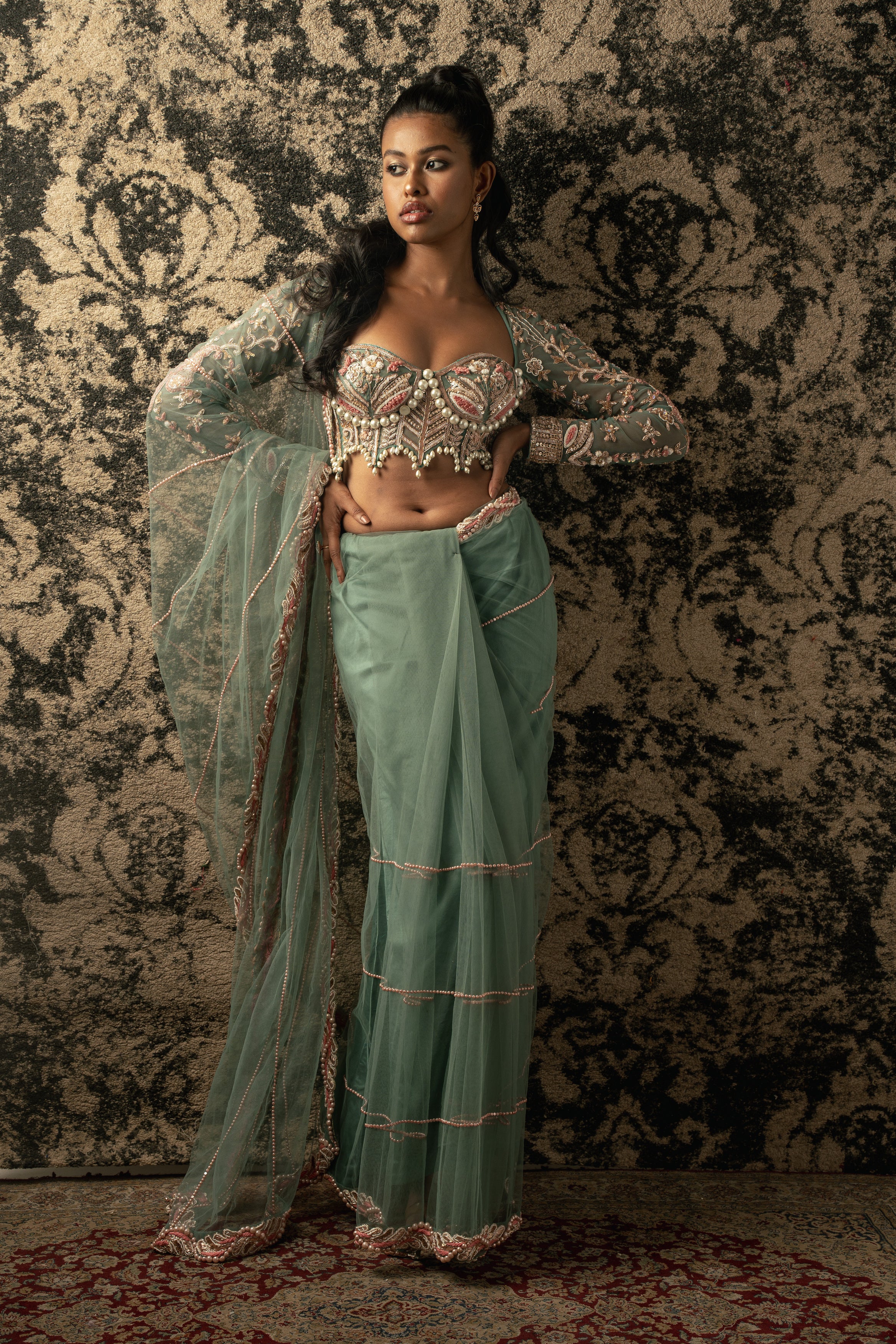 Channeling timeless beauty: This dusky turquoise saree ensemble, crafted from delicate net, exudes grace and sophistication.