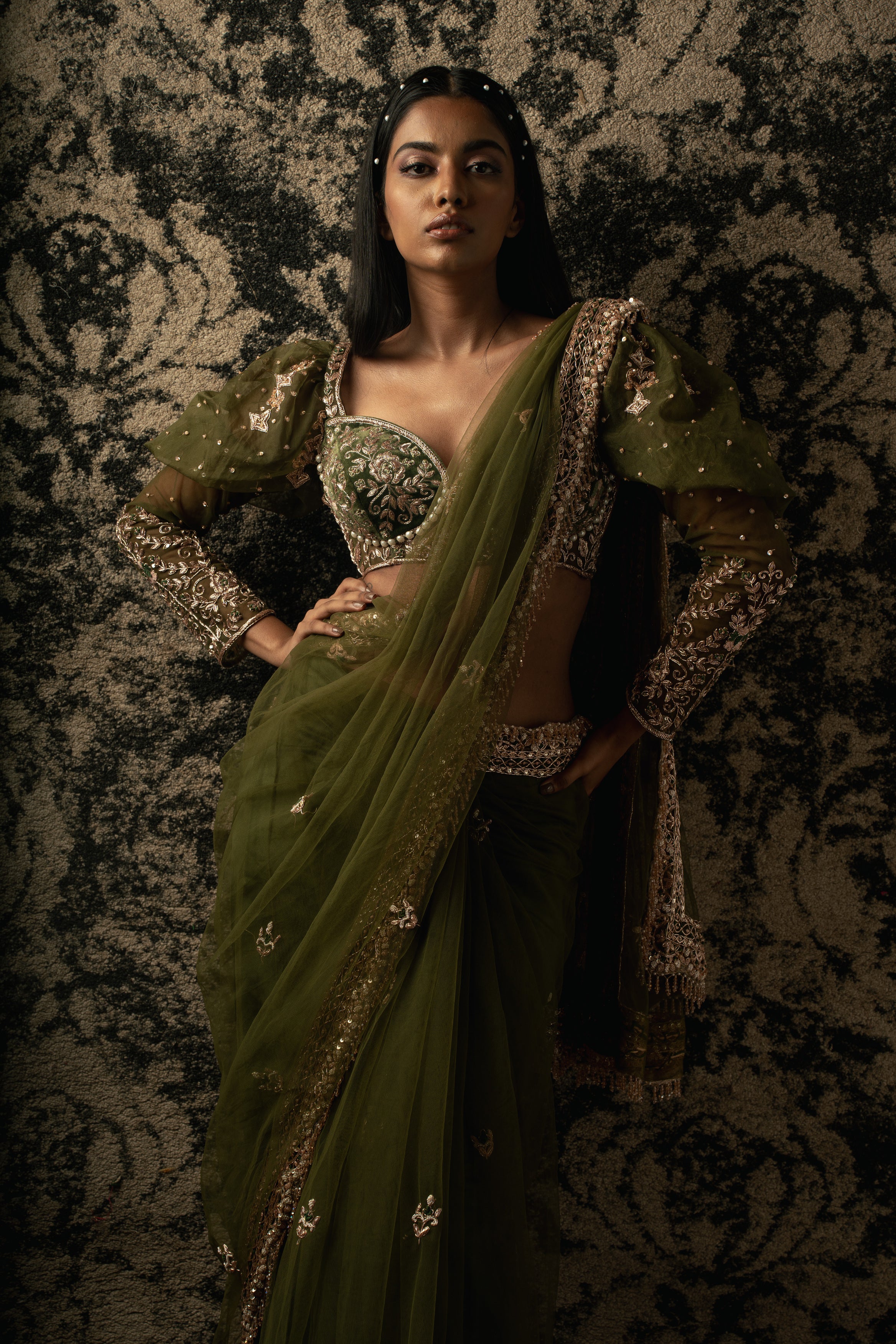 Wrap yourself in sophistication: Olive Green Net Saree paired with a Velvet and Organza blouse, a graceful ode to classic beauty.