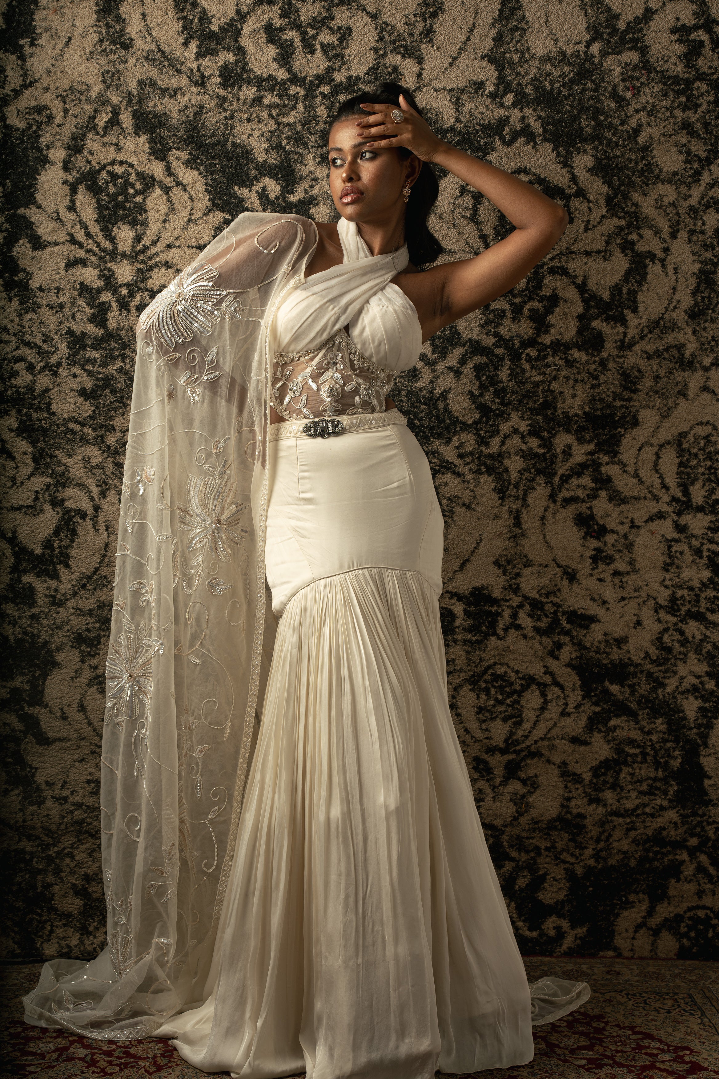 Indulge in opulence: Satin Silk skirt paired with a shimmering Organza and net blouse, topped with an ethereal Organza cape, all in a timeless shade of Ivory.