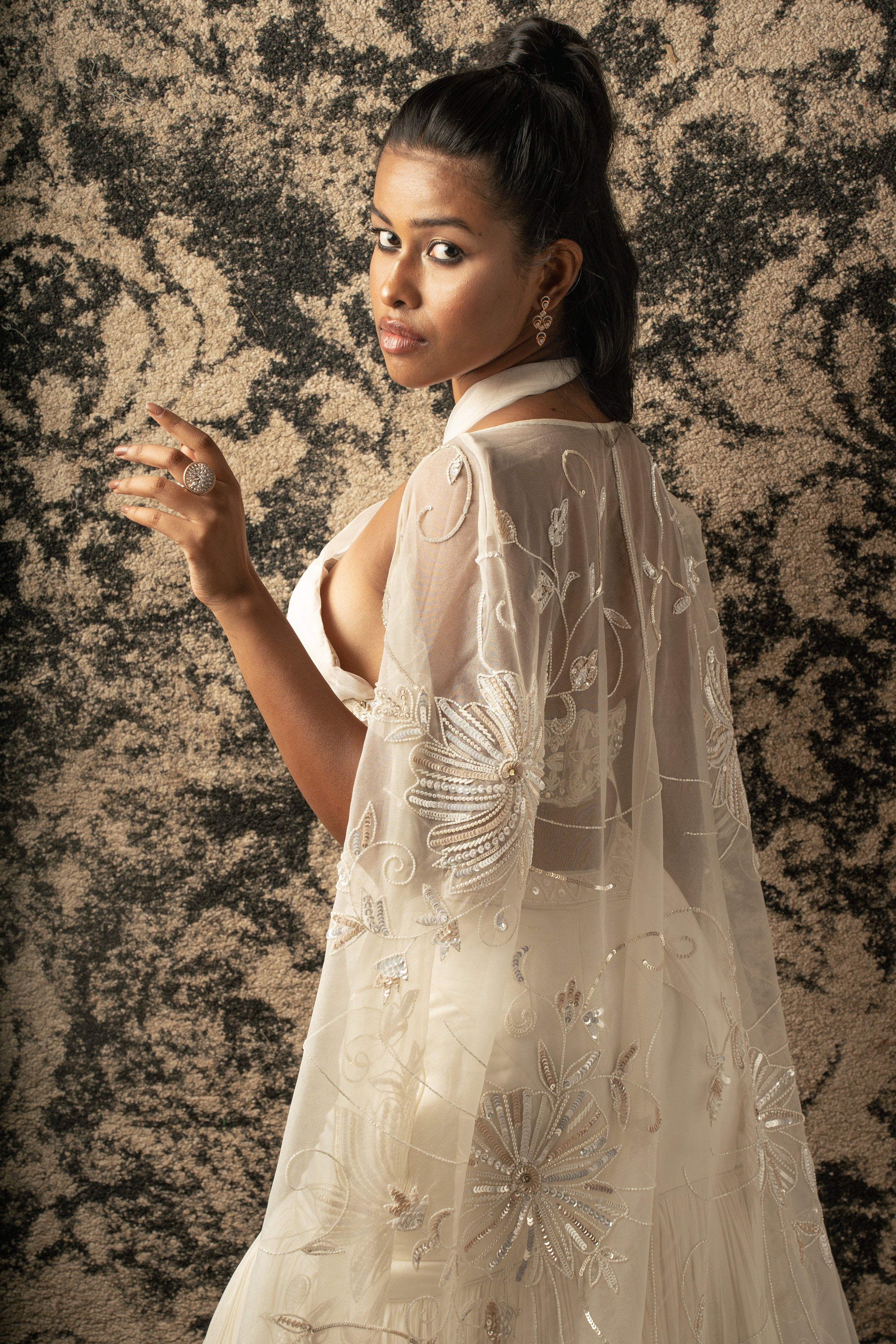 A vision in Ivory: This Fishcut Skirt Lehenga Set boasts a satin silk skirt, paired with a shimmering Organza and net blouse, and crowned with an exquisite Organza cape