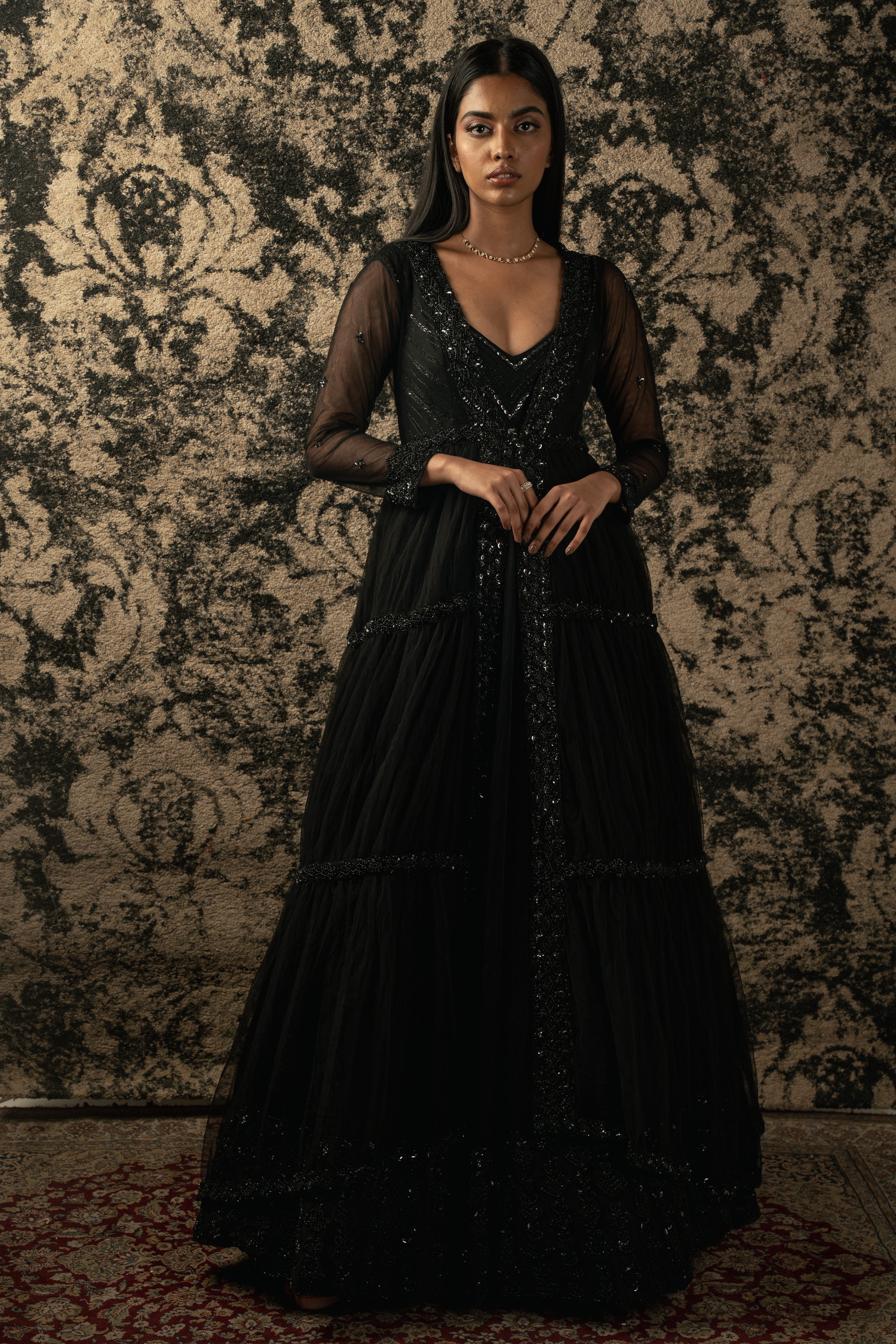 Elegance personified: Black organza Anarkali paired with a delicate net shrug. Embrace timeless beauty.