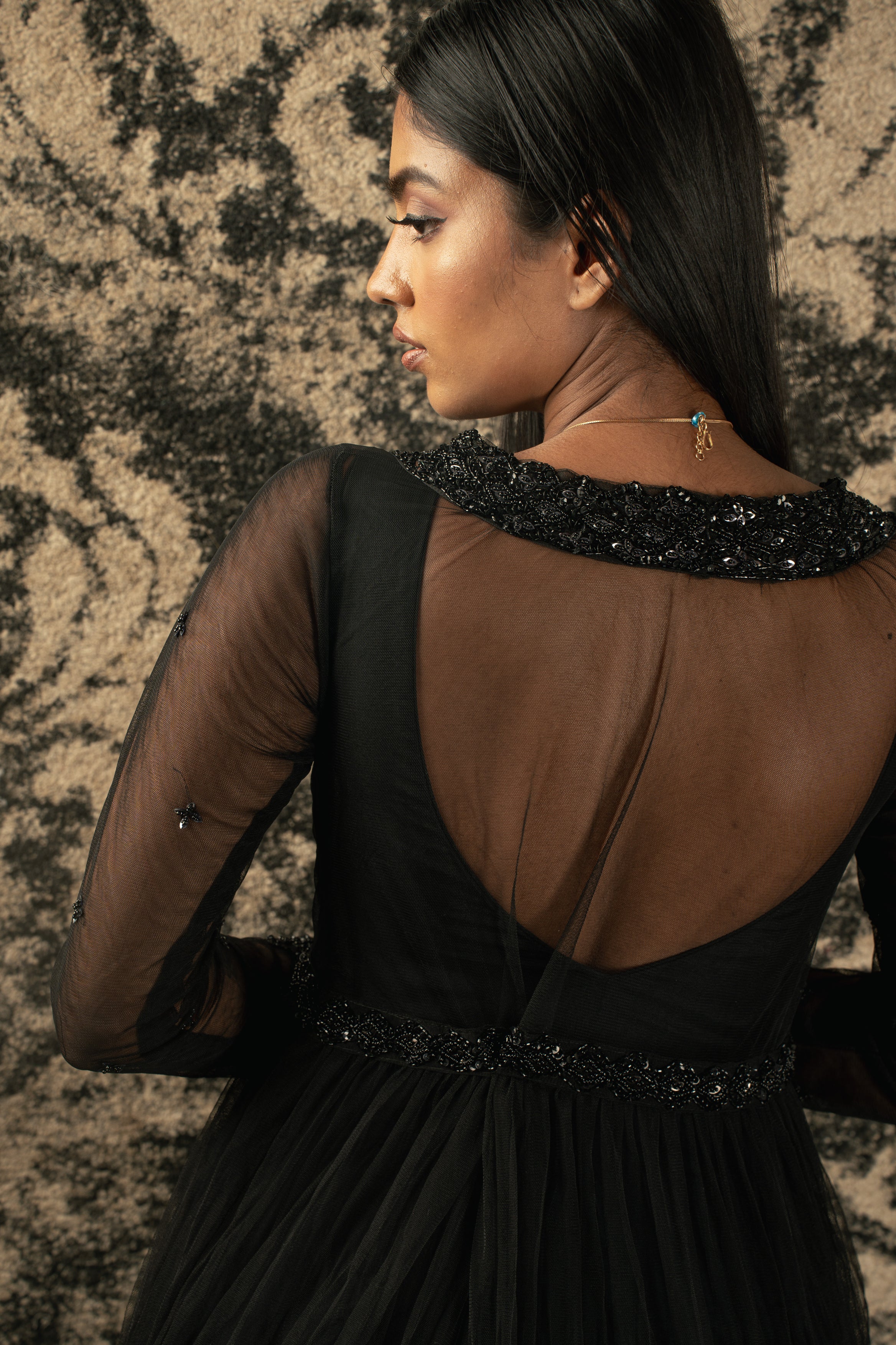 Black is always in style: Step into the spotlight with this exquisite organza Anarkali and matching net shrug.