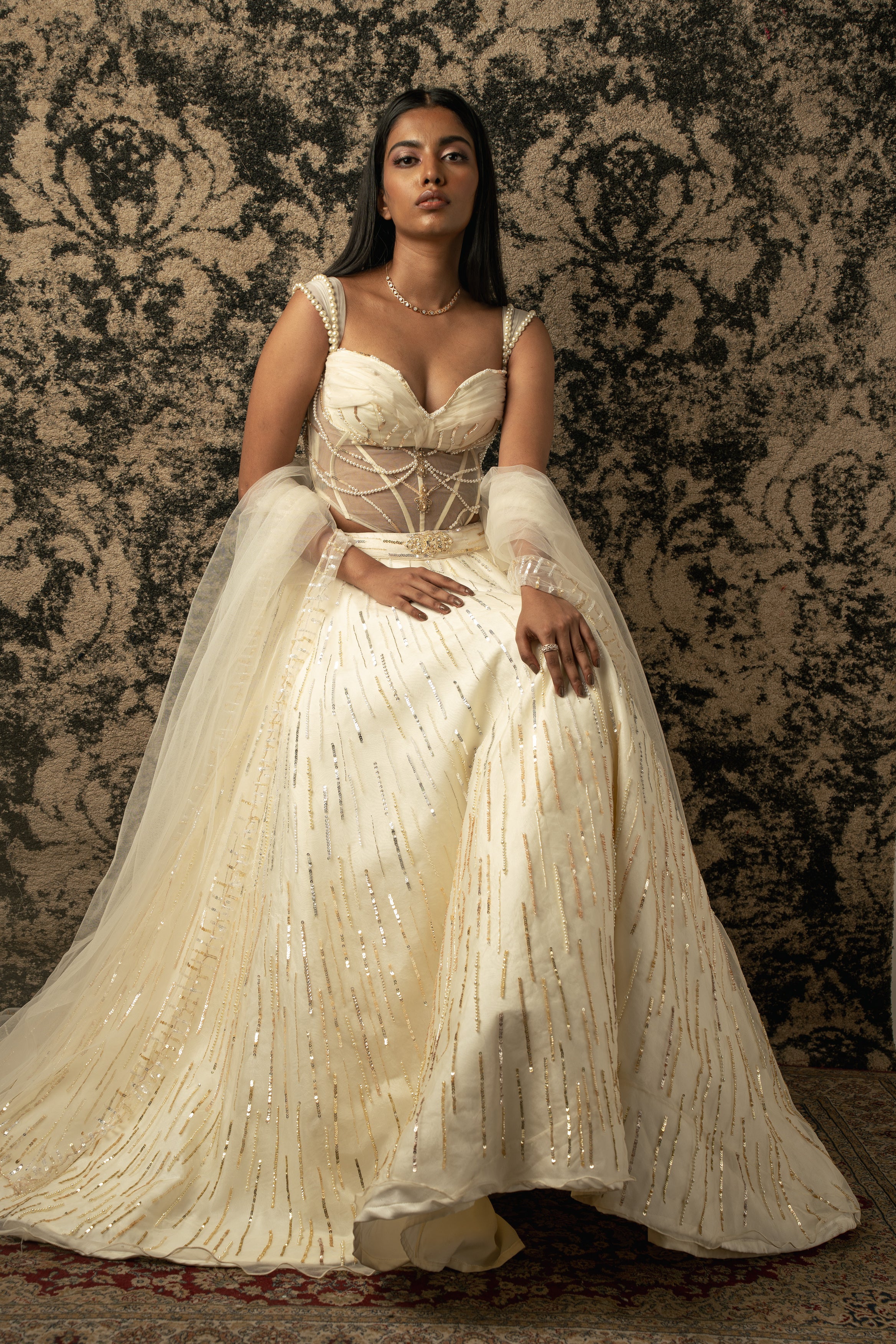 Embrace sophistication in this Ivory Lehenga, where delicate Organza and net blend seamlessly into a vision of timeless beauty