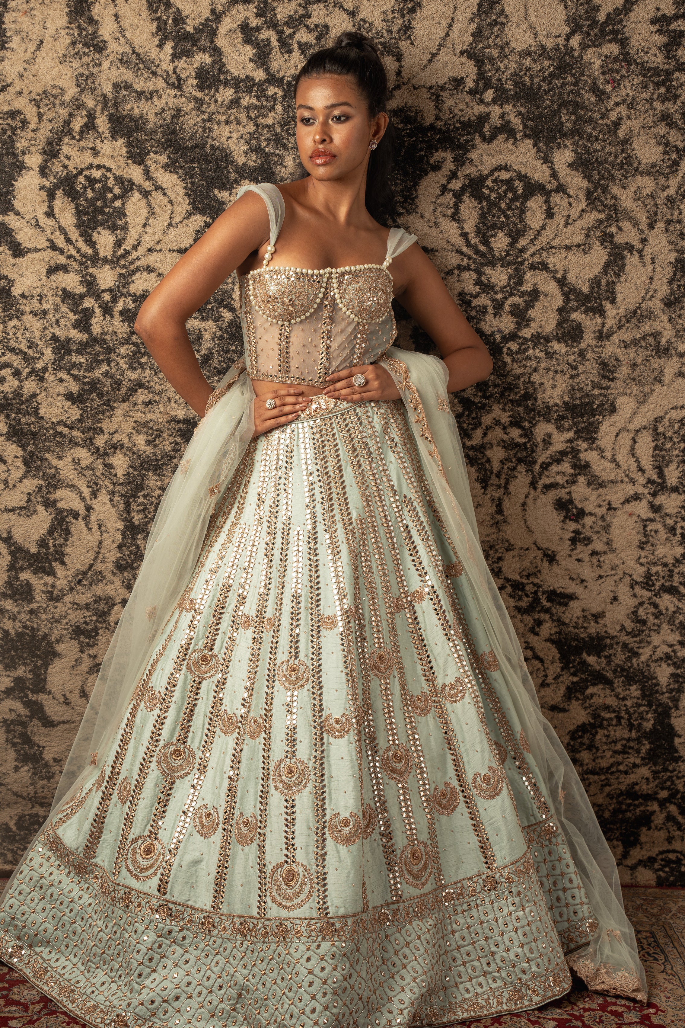 Embrace the freshness of Mint Green: Raw silk Lehenga paired with a delicate Net and Raw Silk blouse, adorned with a sheer Net Dupatta, a divine ensemble for any occasion.