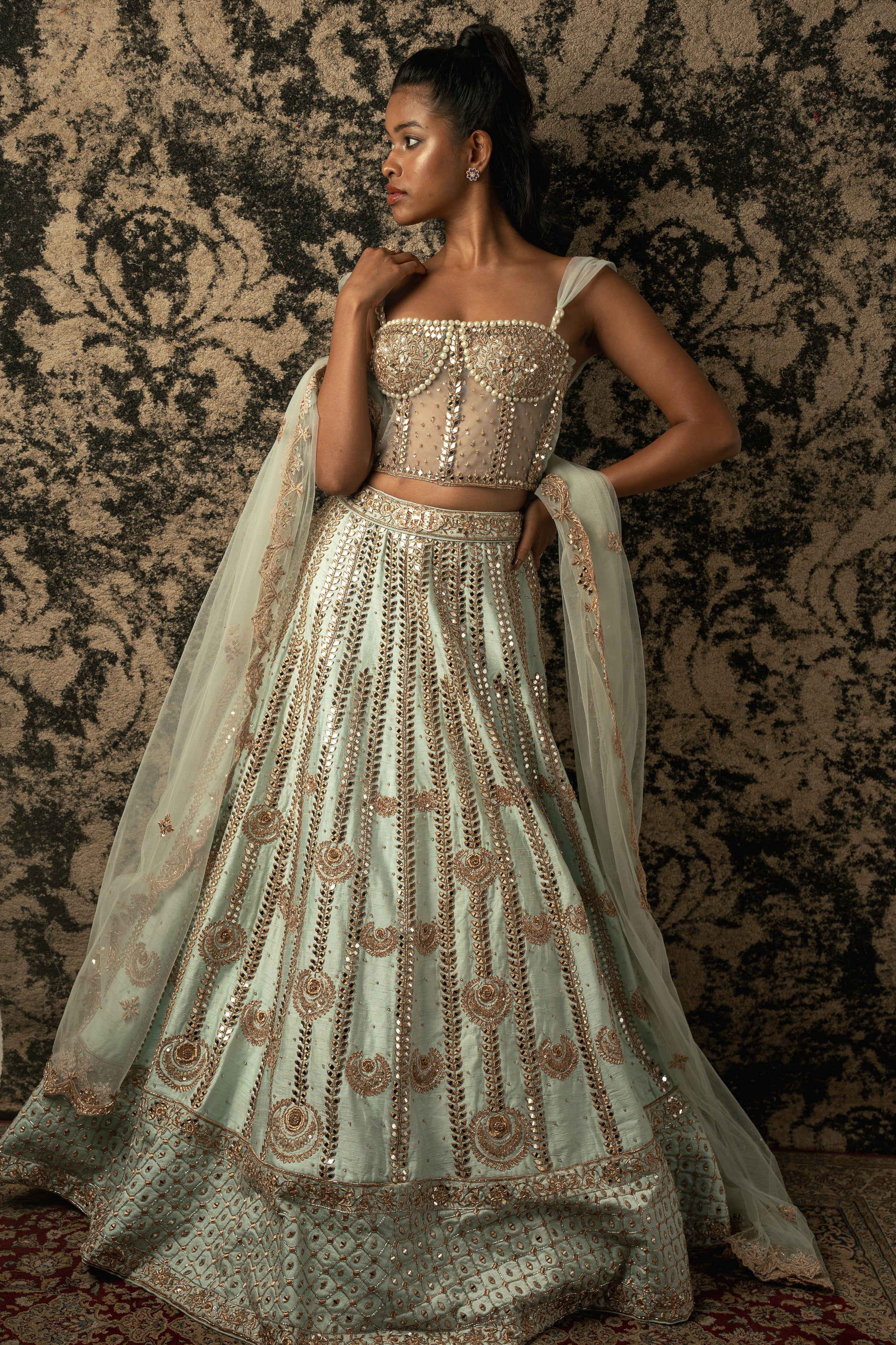 Elevate your charm in Mint Green: Raw silk Lehenga with Net and Raw Silk blouse, complemented by a flowing Net Dupatta, exuding timeless elegance and grace.