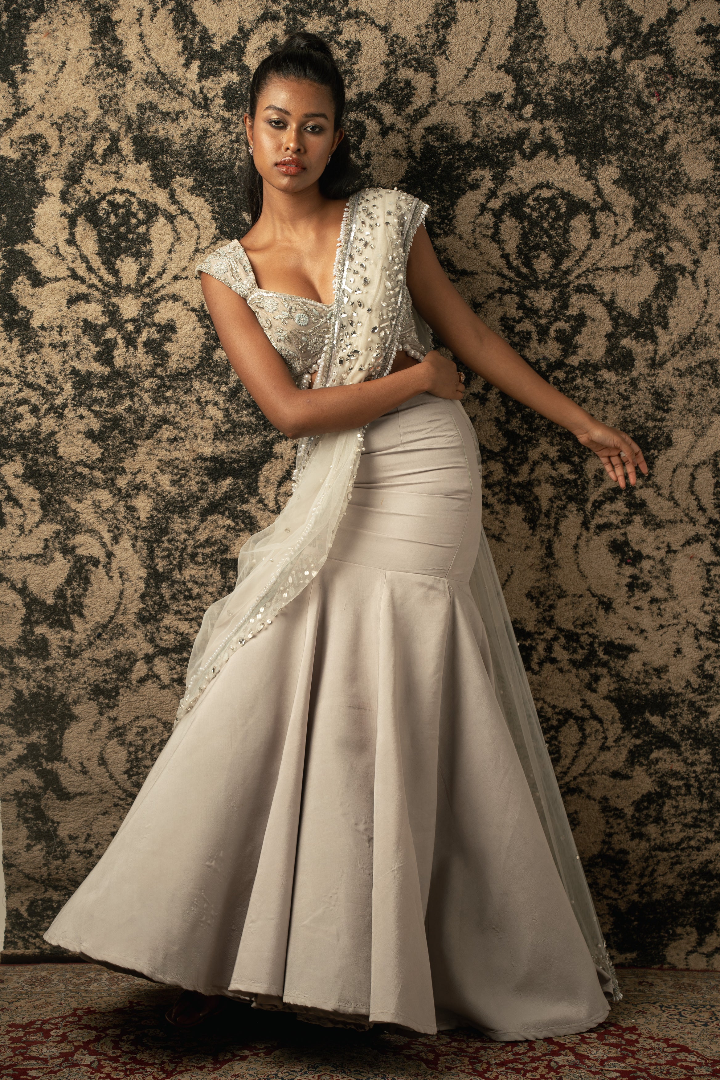 Graceful sophistication in Chalk: Net Drape Saree paired with Velvet blouse and Habutai Silk skirt, a timeless combination of beauty and charm.