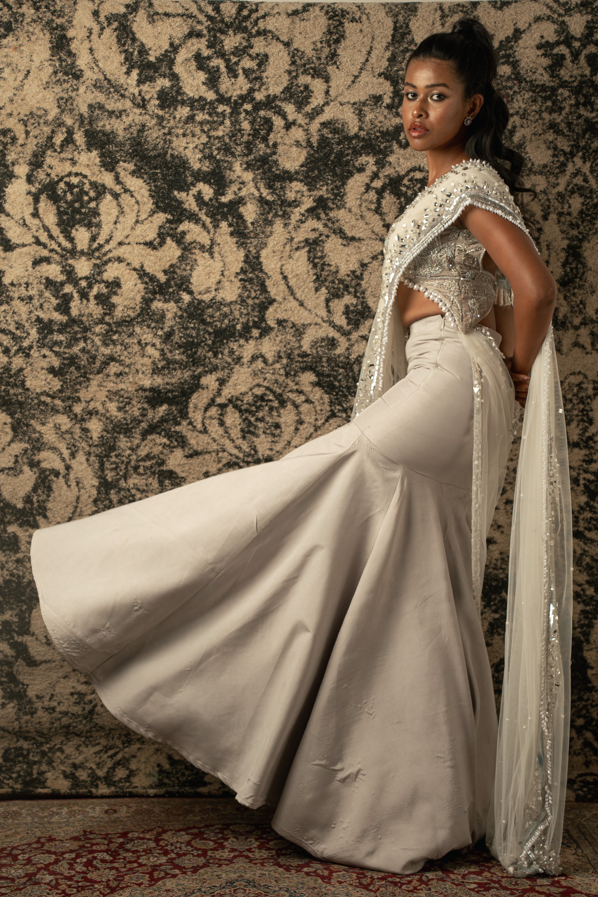 Radiant in Chalk: Drape yourself in this exquisite Net Saree with a Velvet blouse and Habutai Silk skirt ensemble, a true embodiment of grace.