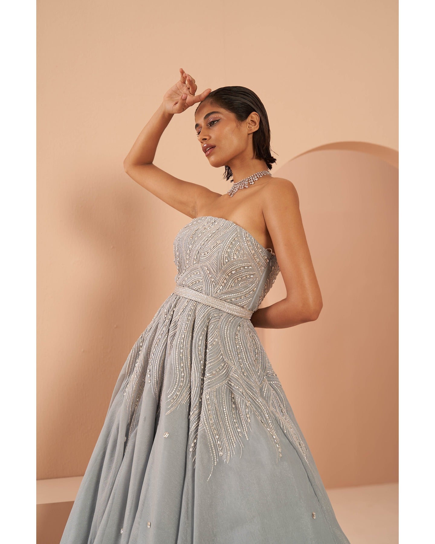 Ice Queen Elegance: Hand-embroidered perfection graces this strapless ice blue gown, a captivating blend of sophistication and charm.