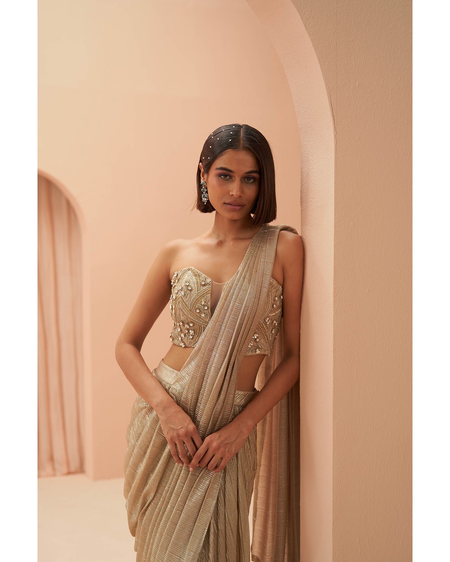 Gilded Grace: Hand-embroidered enchantment graces this golden drape saree, a radiant masterpiece of timeless elegance.