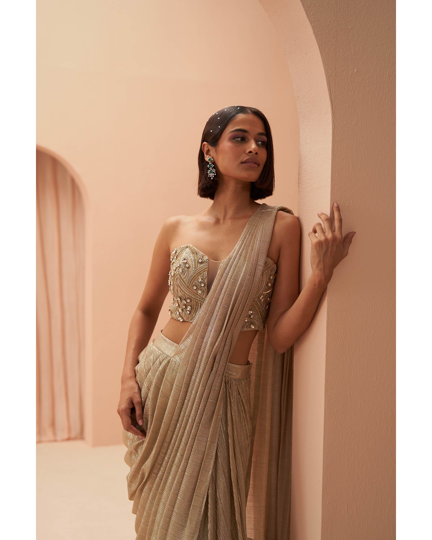 Gilded Grace: Hand-embroidered enchantment graces this golden drape saree, a radiant masterpiece of timeless elegance.