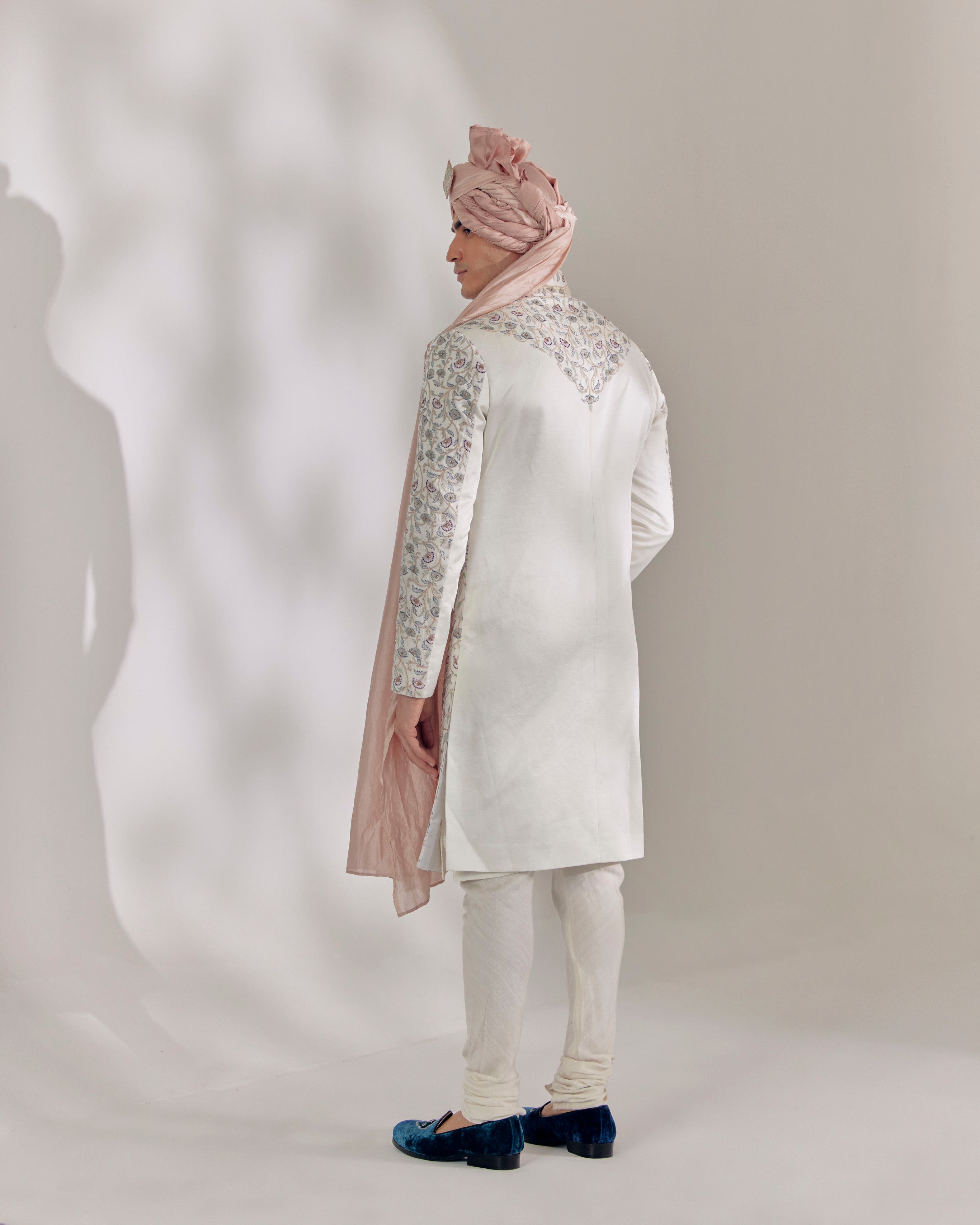 Unveil your regal charm with the White Vine Sherwani.