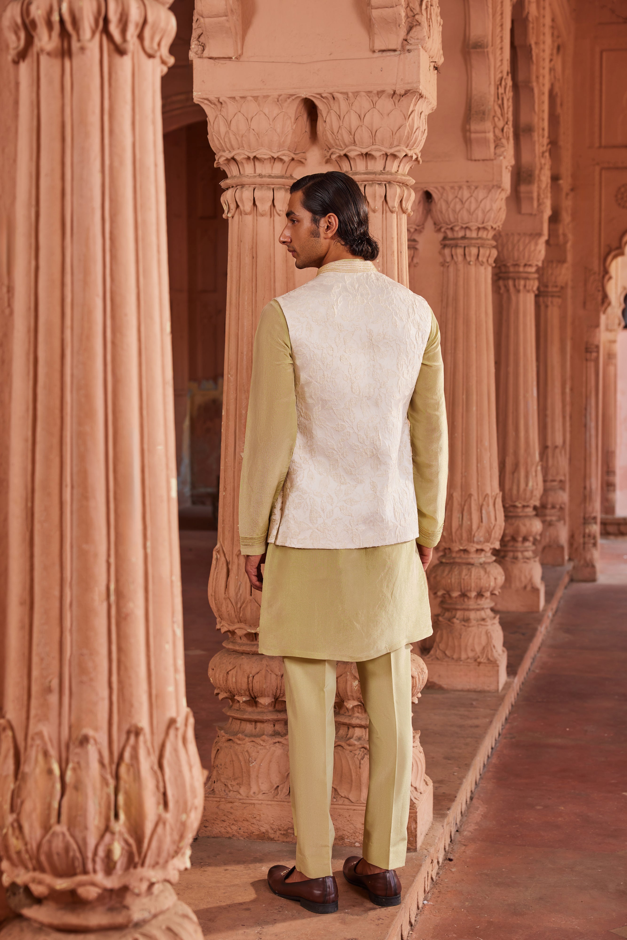 A sophisticated Jannat Nehru Jacket Set, showcasing a textured silk jacquard jacket with gold bead detailing, paired with a contrast detail kurta and pants for an elegant look
