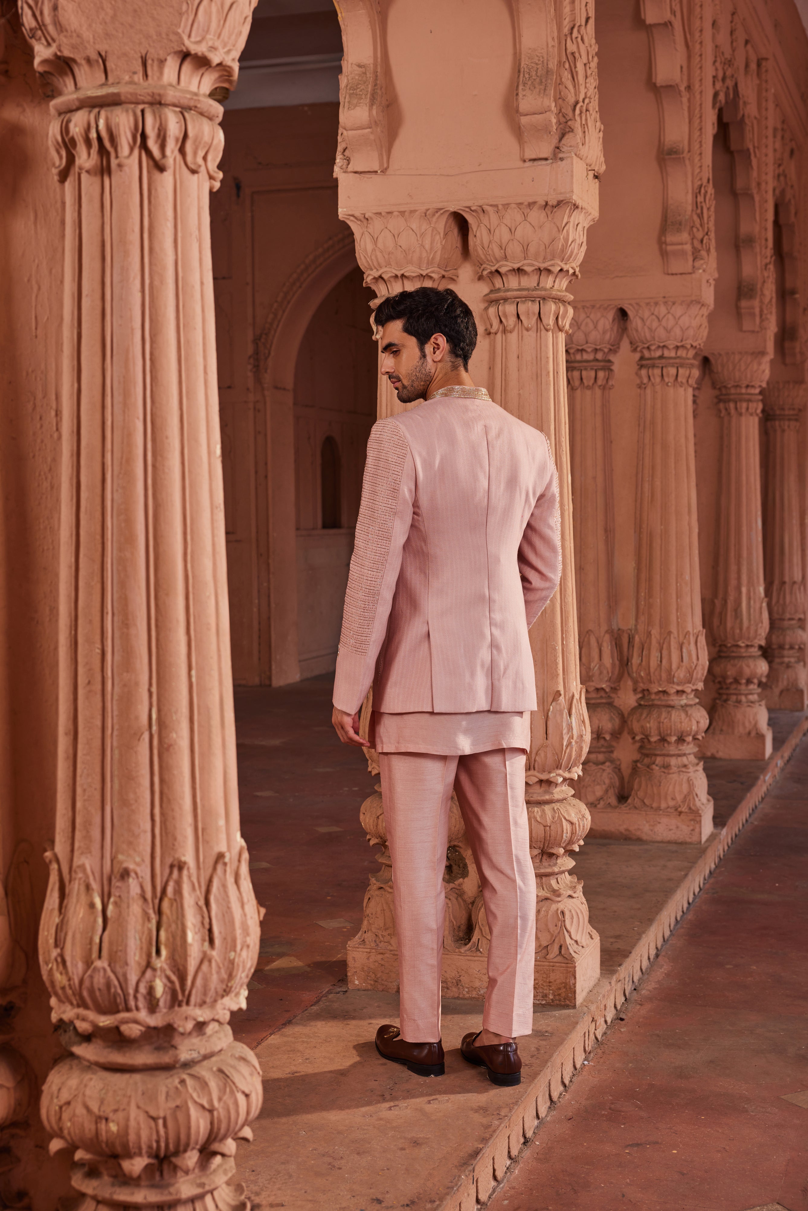 Full view of a richly embroidered jacket with tonal floral and line patterns, enhanced by tissue applique work, paired with a detailed kurta and pants for a sophisticated and elegant ensemble.