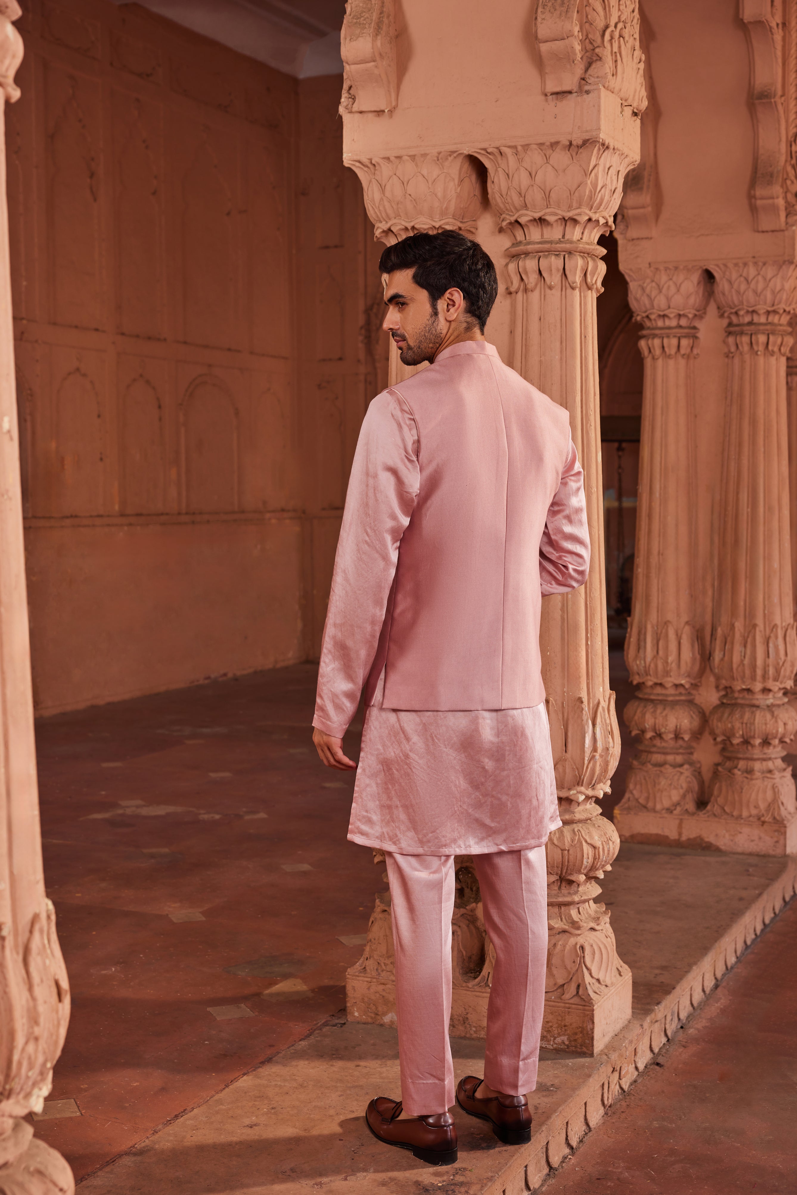 A refined Husn Nehru Jacket Set showcasing a jacket decorated with hand-painted motifs and embellished with dabka and zardozi embroidery, paired with a simple monotone kurta and pants