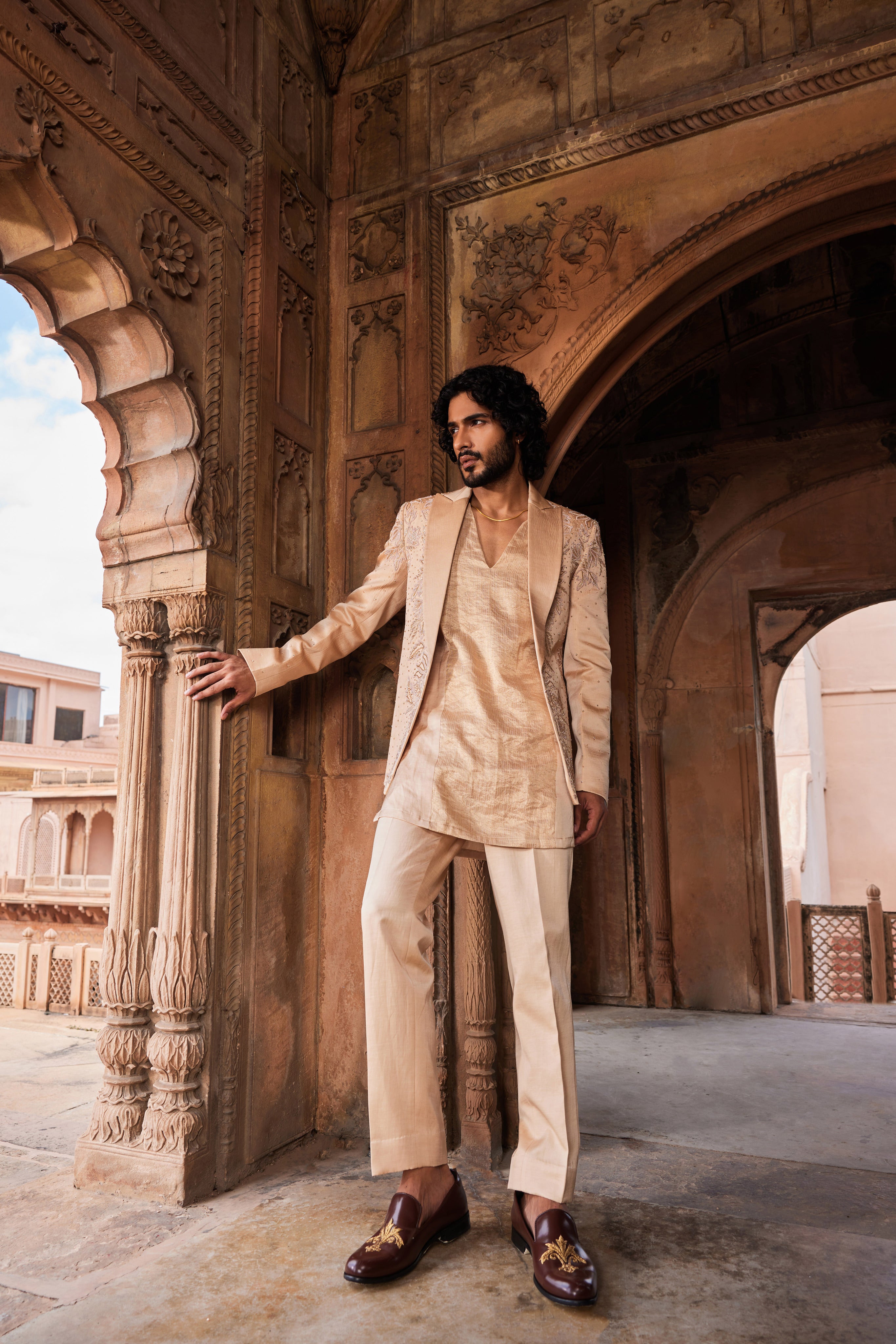 A Tabeer Jacket Set showcasing a richly embroidered jacket adorned with floral designs and embellished with crystals, zardozi, cutdana, and dabka work. The ensemble includes a panel-detailed kurta and pants