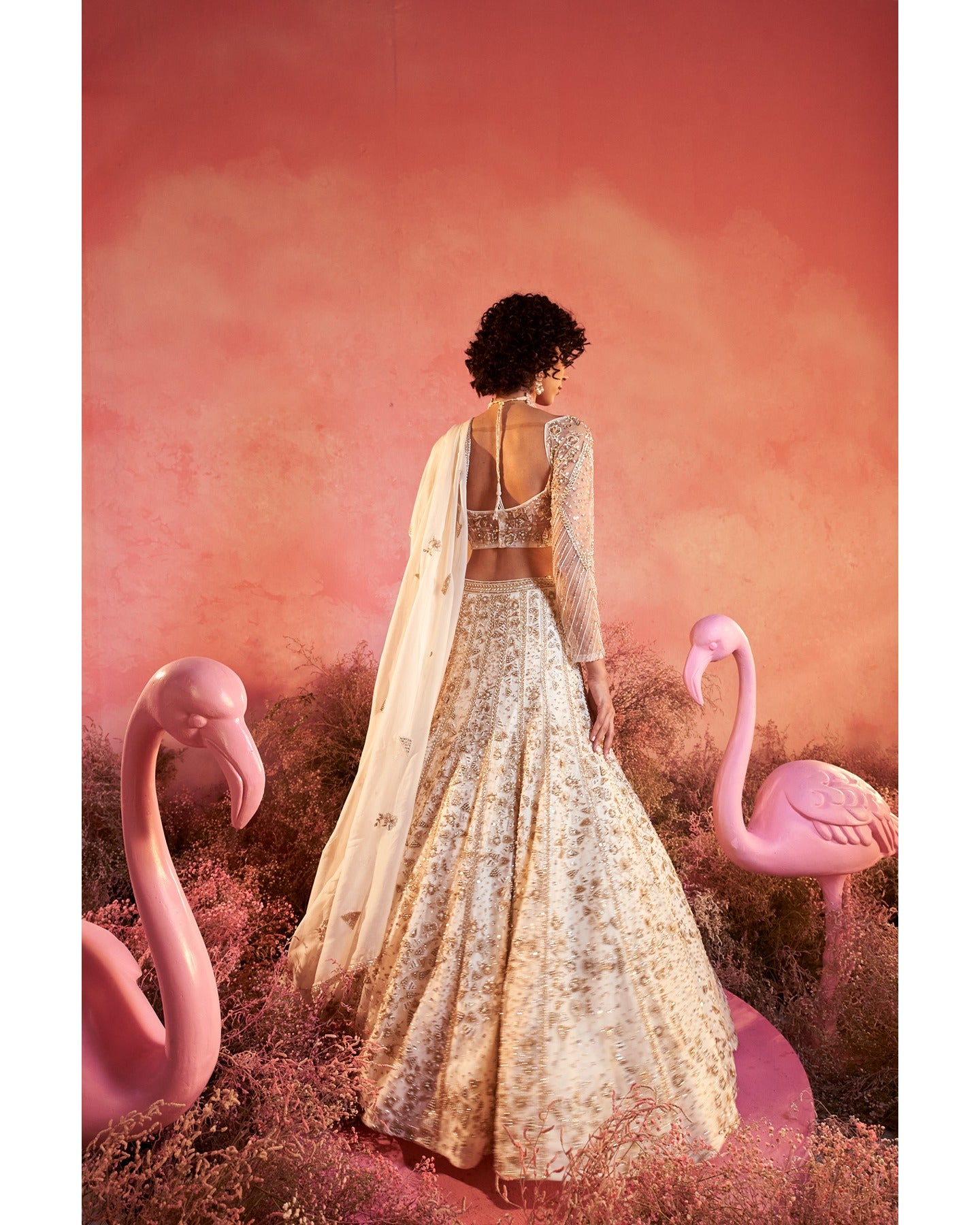 Elegance in every stitch: A white hand-embroidered lehenga that weaves a tale of grace and sophistication.