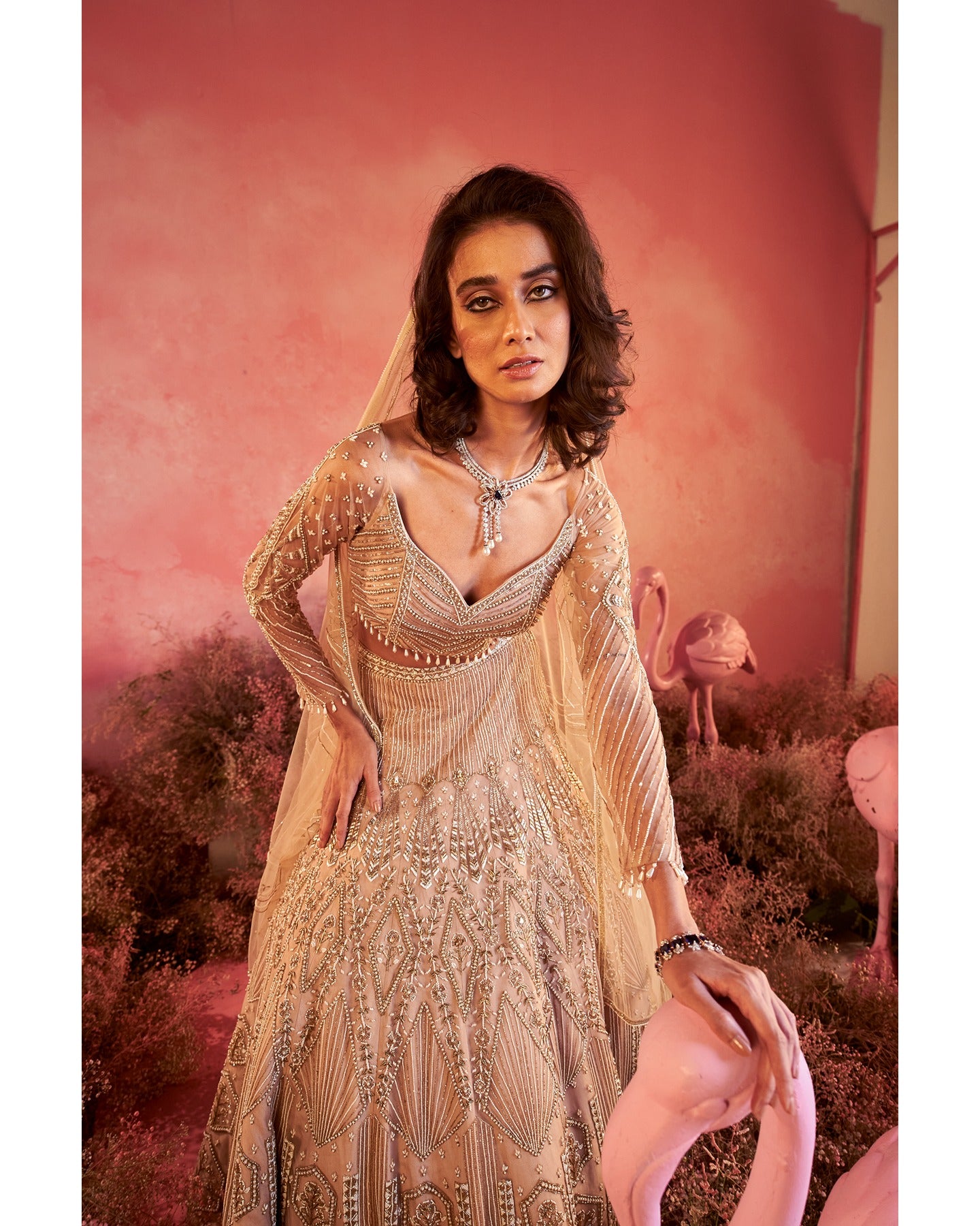 Whispers of artistry in nude tones: A hand-embroidered lehenga that radiates elegance and grace.