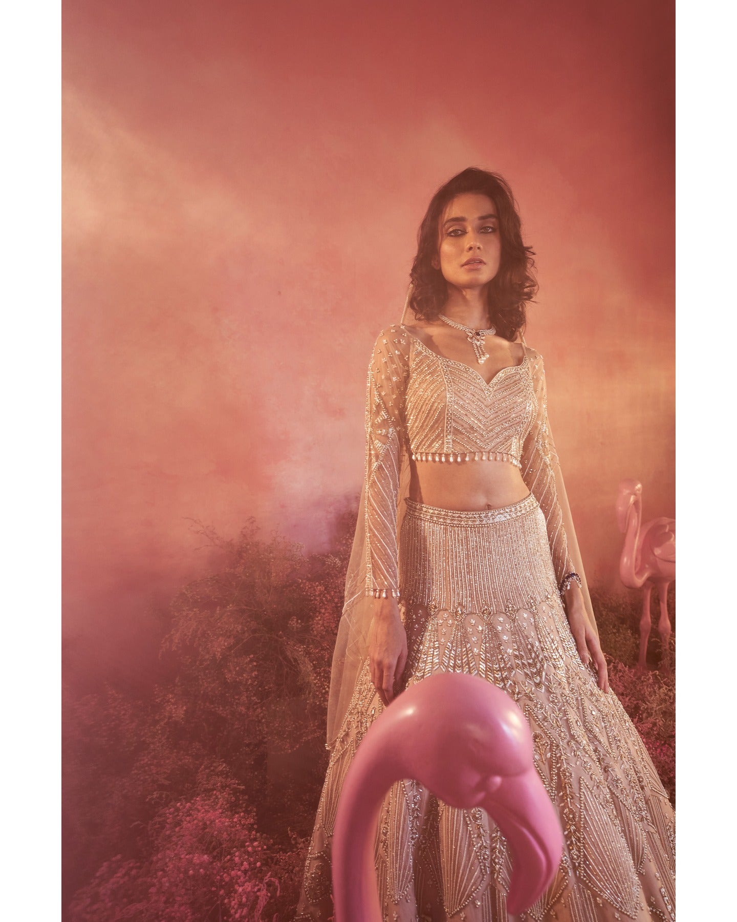 Whispers of artistry in nude tones: A hand-embroidered lehenga that radiates elegance and grace.