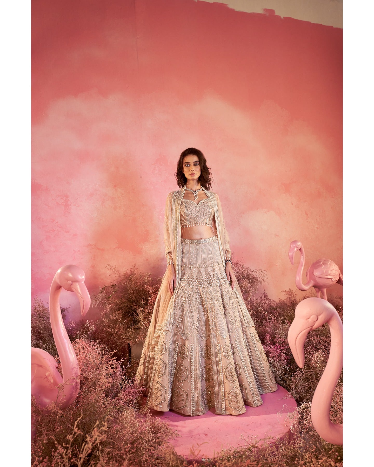 Whispers of artistry in nude tones: A hand-embroidered lehenga that radiates elegance and grace.