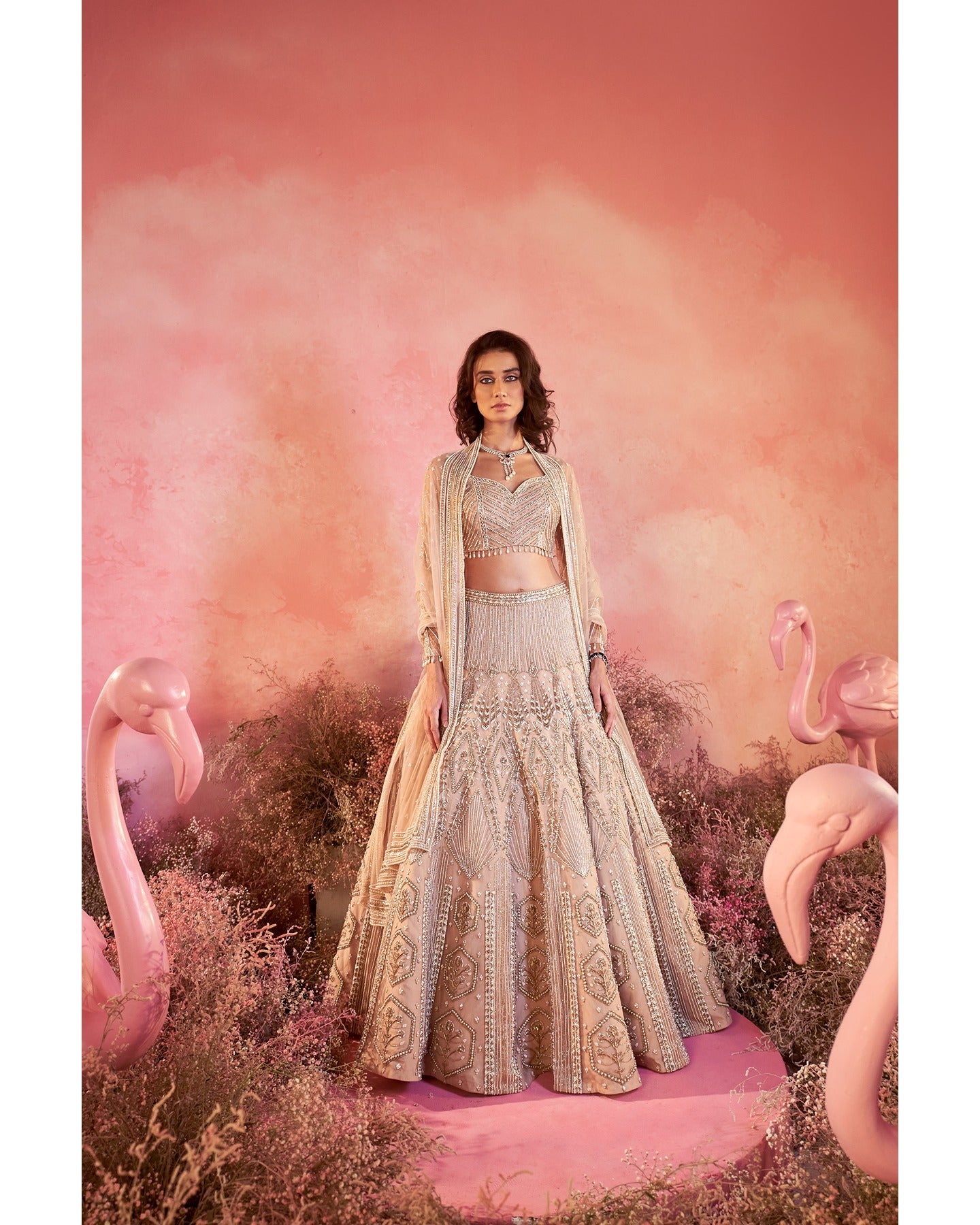 Whispers of artistry in nude tones: A hand-embroidered lehenga that radiates elegance and grace.