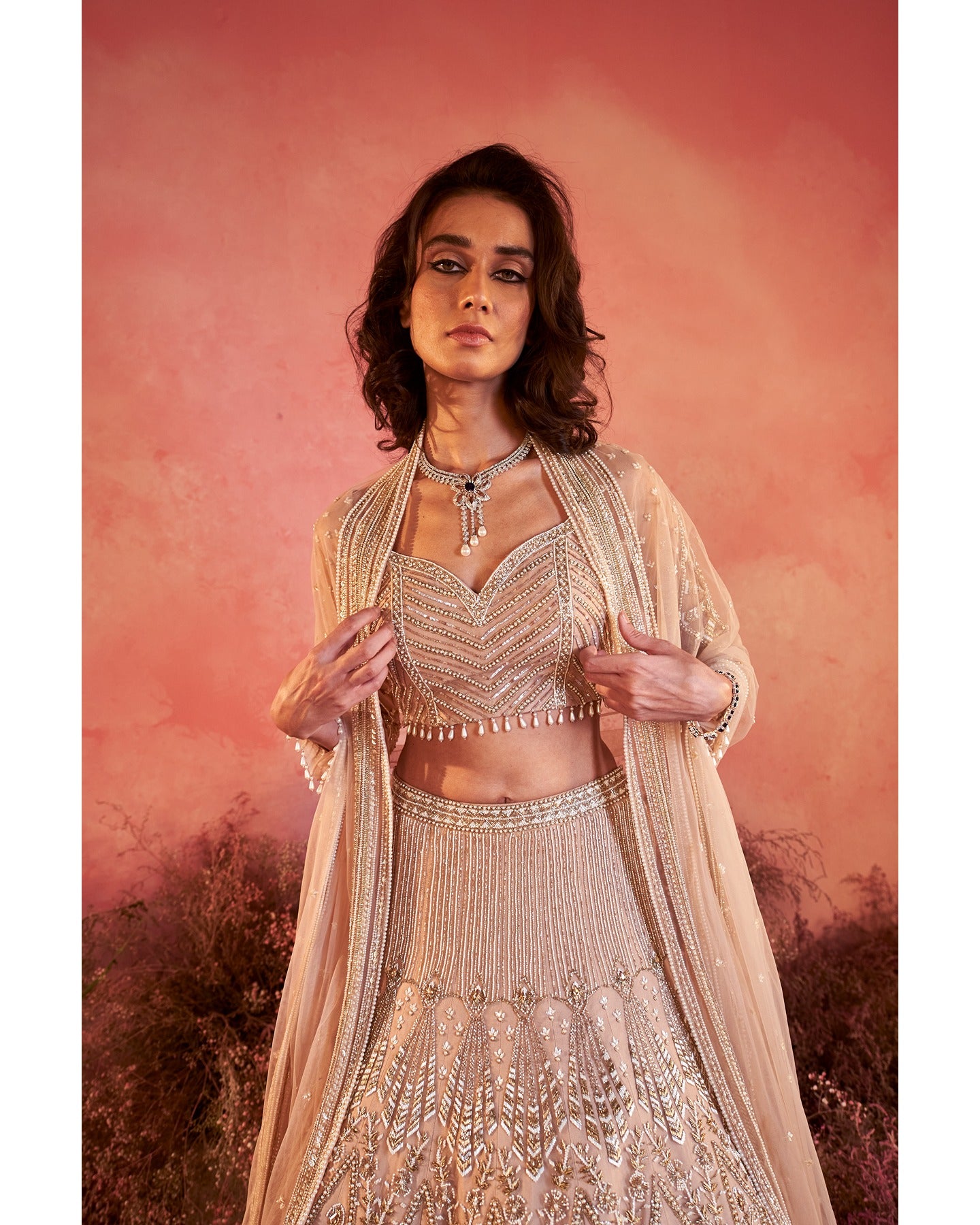 Whispers of artistry in nude tones: A hand-embroidered lehenga that radiates elegance and grace.