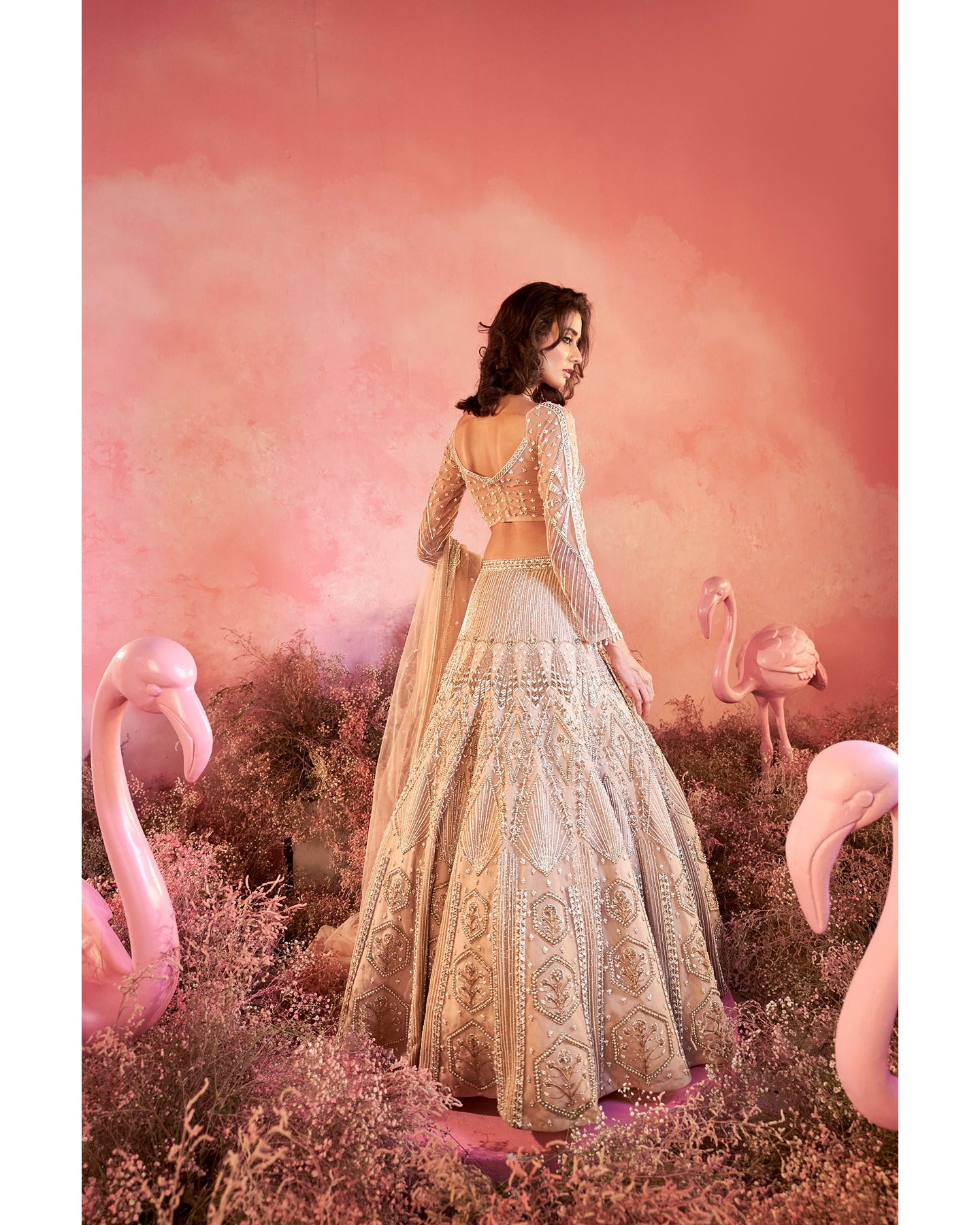 Whispers of artistry in nude tones: A hand-embroidered lehenga that radiates elegance and grace.