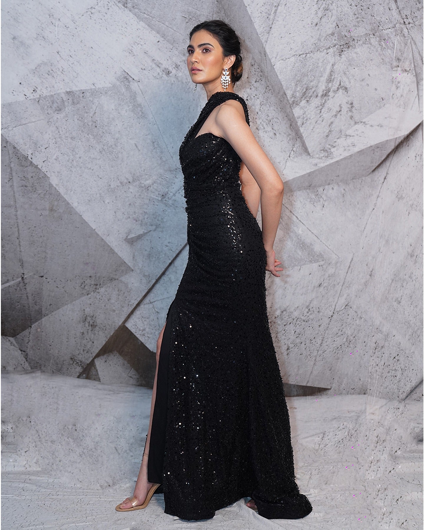 Draped in the allure of midnight black, this gown is a canvas of elegance and shimmering sophistication.