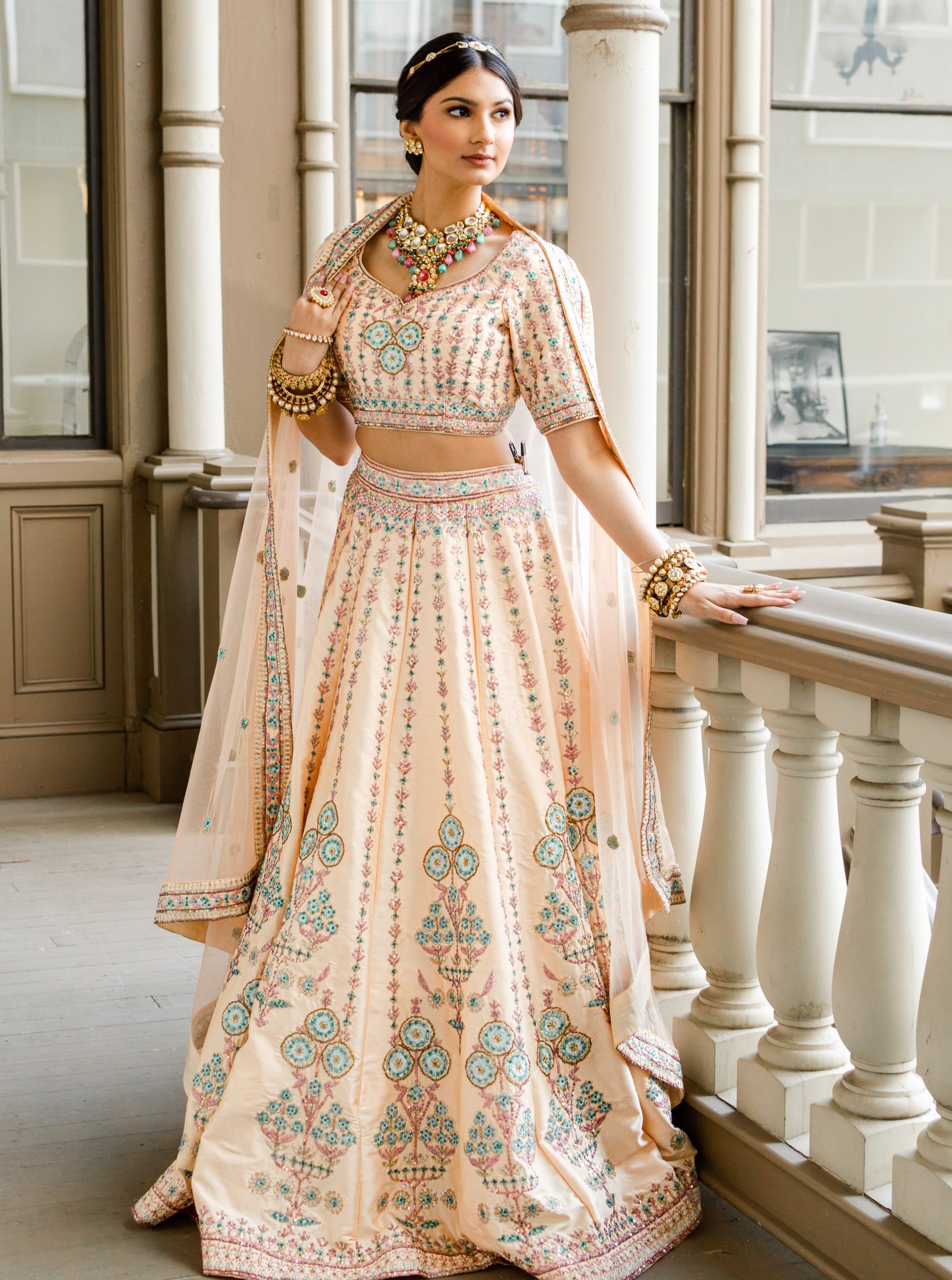 Peachy bridal lehenga with pastel embroidery