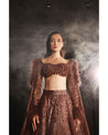 Embrace the allure of the Orave lehenga with its choli cut blouse adorned in Swarovski crystals, feathers, and sequins, complemented by a captivating feather cape.