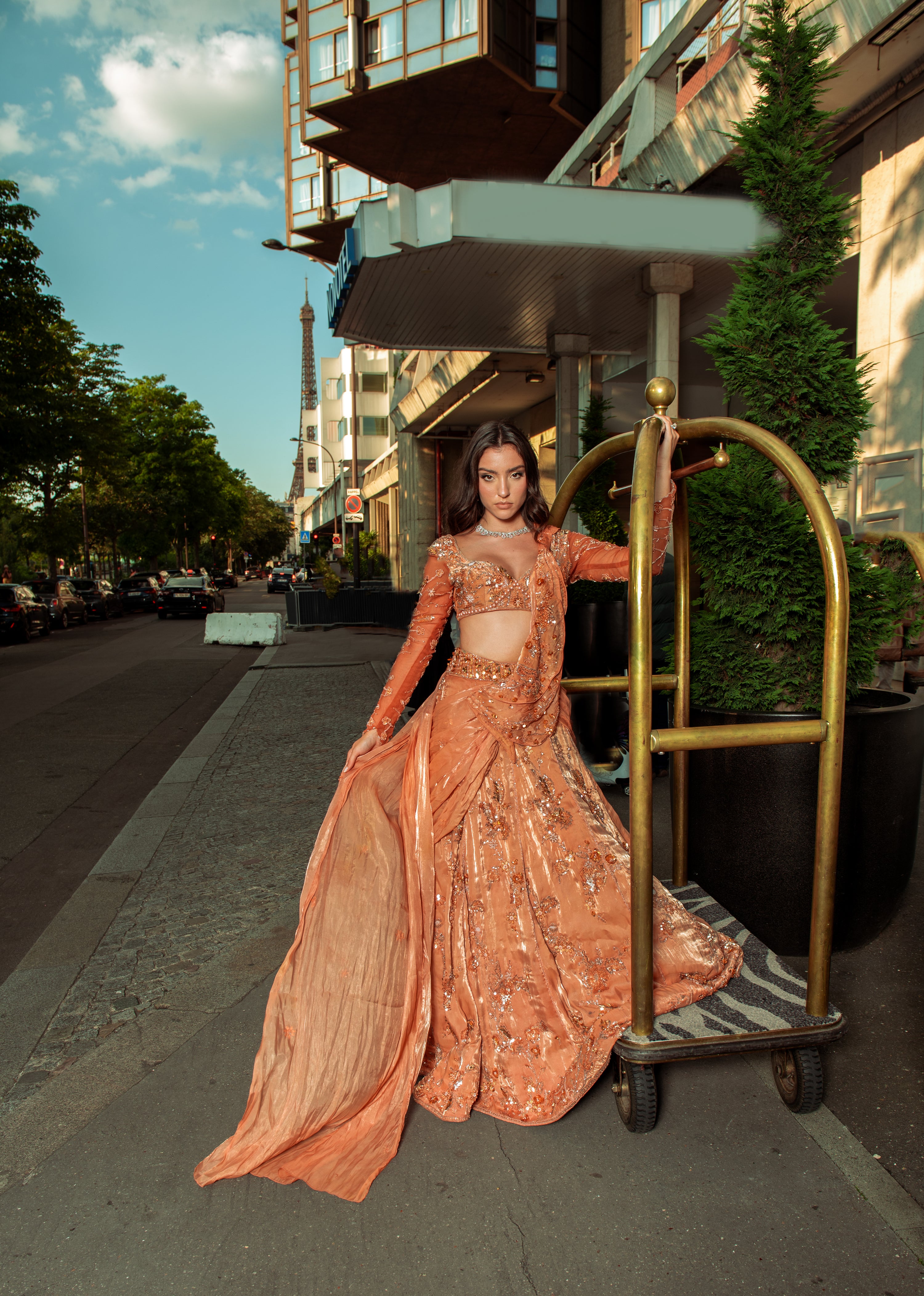 Salmon orange pre-draped saree in shimmer organza, featuring intricate handwork embroidery. This ensemble combines vibrant color with delicate craftsmanship, offering effortless elegance for weddings and special occasions