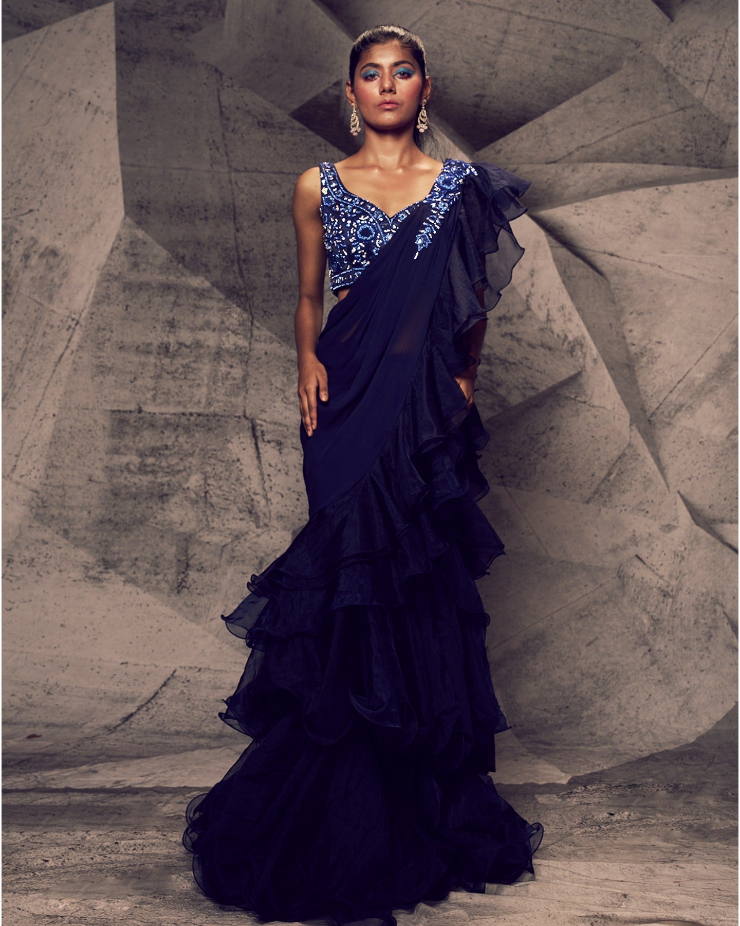 Draped in the captivating hues of blue, this gown is a symphony of glamour and sophistication, adorned with intricate floral embroidery, stones, sequins, and kardana beads. 