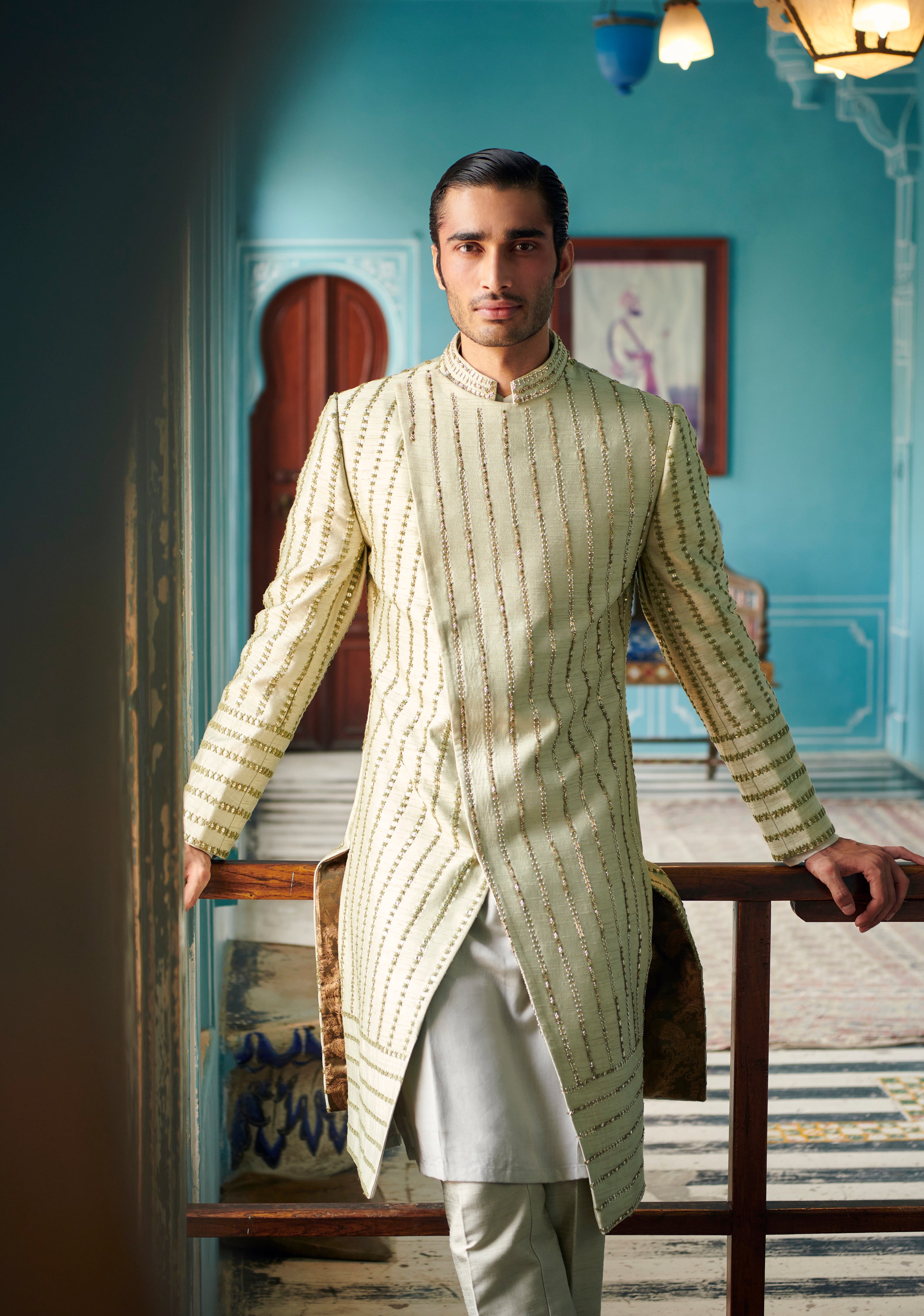 Make a statement in our Sherwani Set, blending raw silk luxury with linen satin comfort in a soothing pale olive. Customizable to your taste, it's the perfect ensemble for celebrating life's unforgettable moments. 
