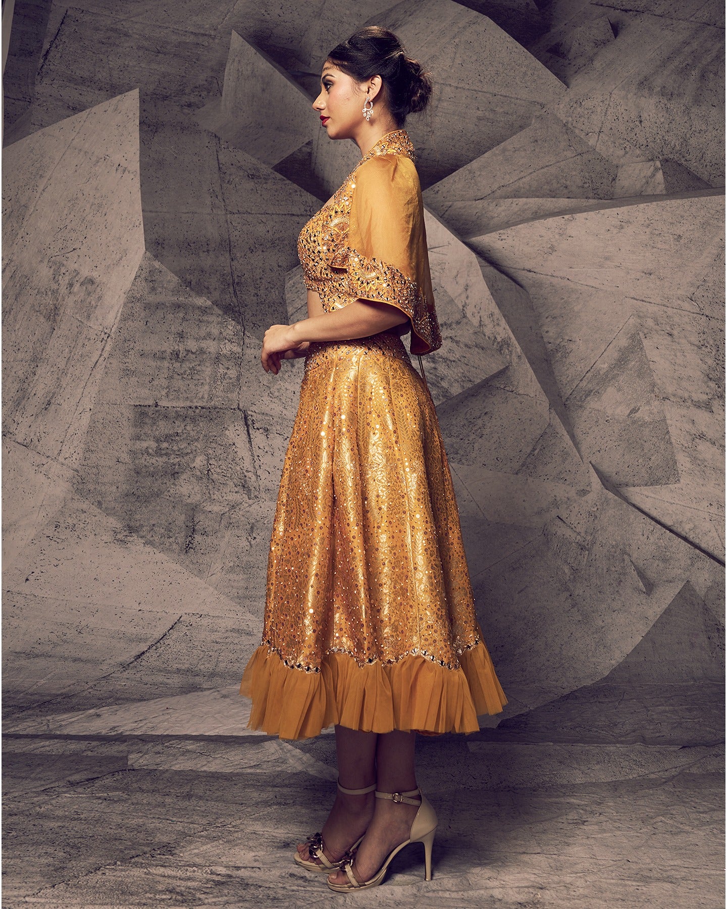 Bathed in the radiant hues of marigold, this short lehenga ensemble is a burst of festive charm.