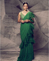 Draped in the festive hues of green, this saree is a symphony of elegance and contemporary flair. 